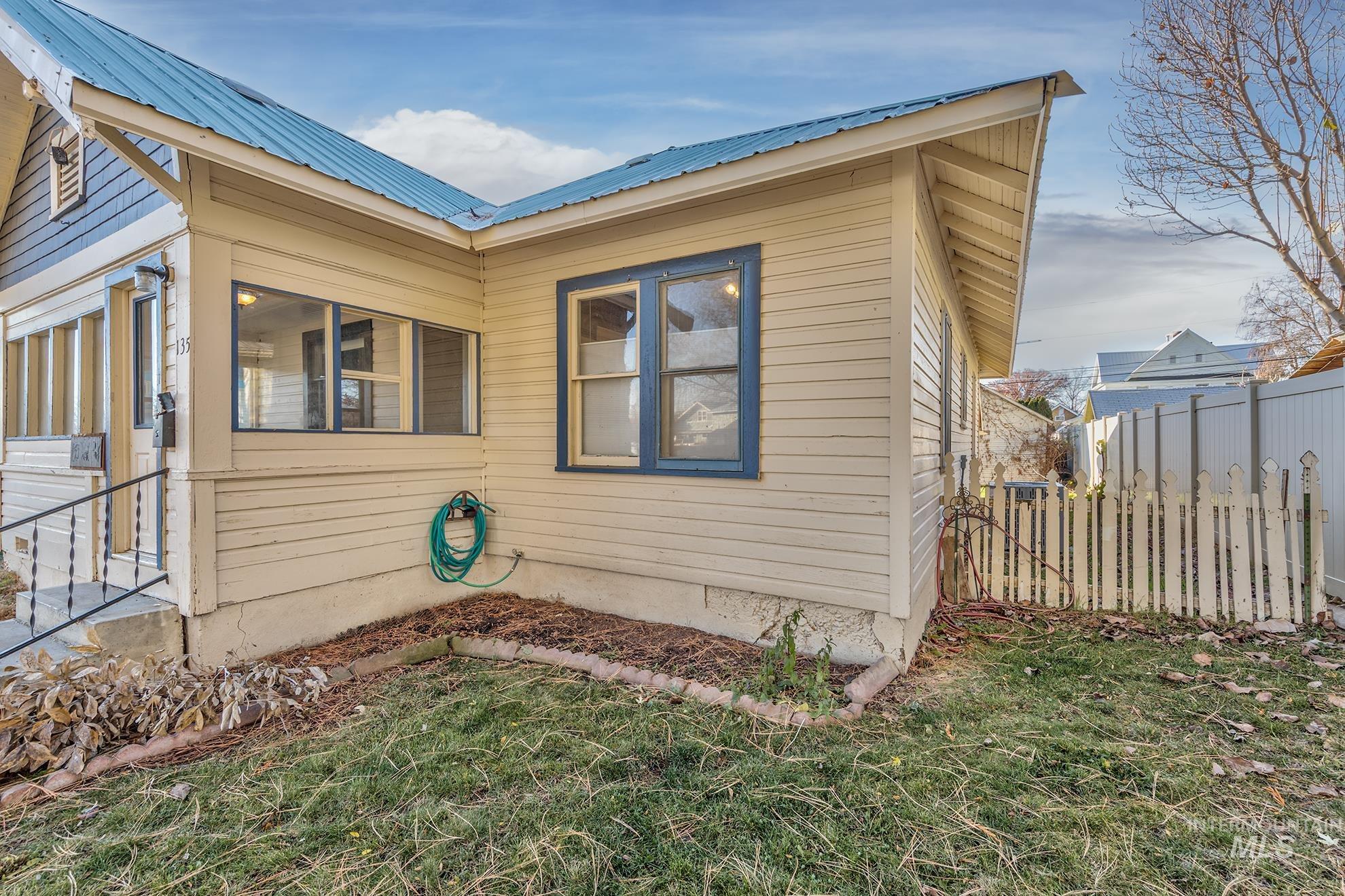 View of side of home with a metal roof
