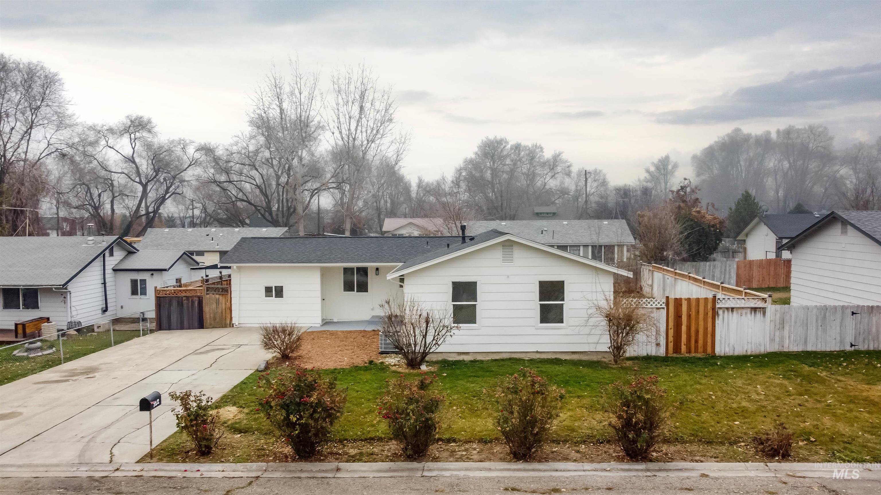 View of front of home featuring concrete driveway and a residential view