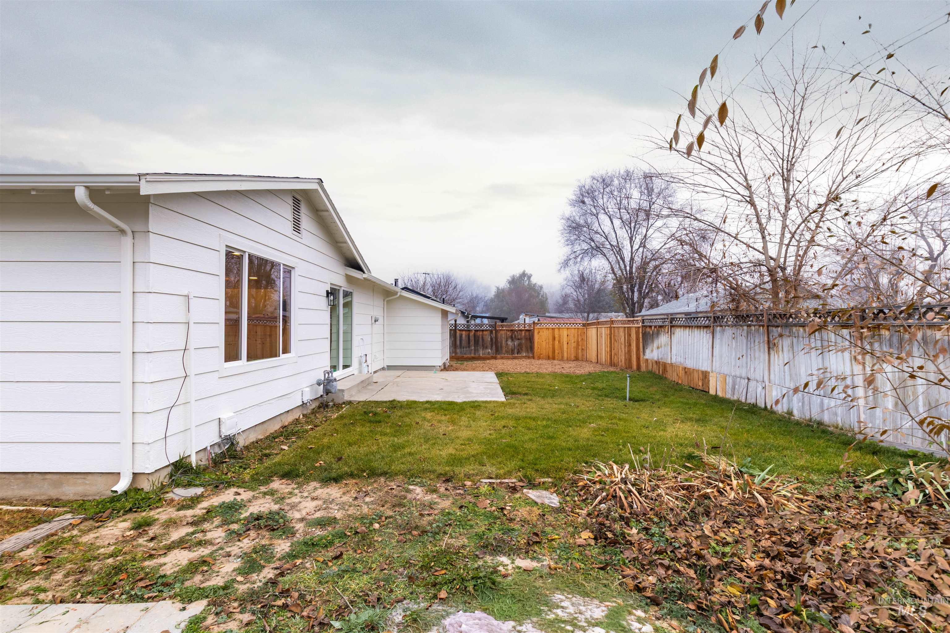 Fenced backyard featuring a patio