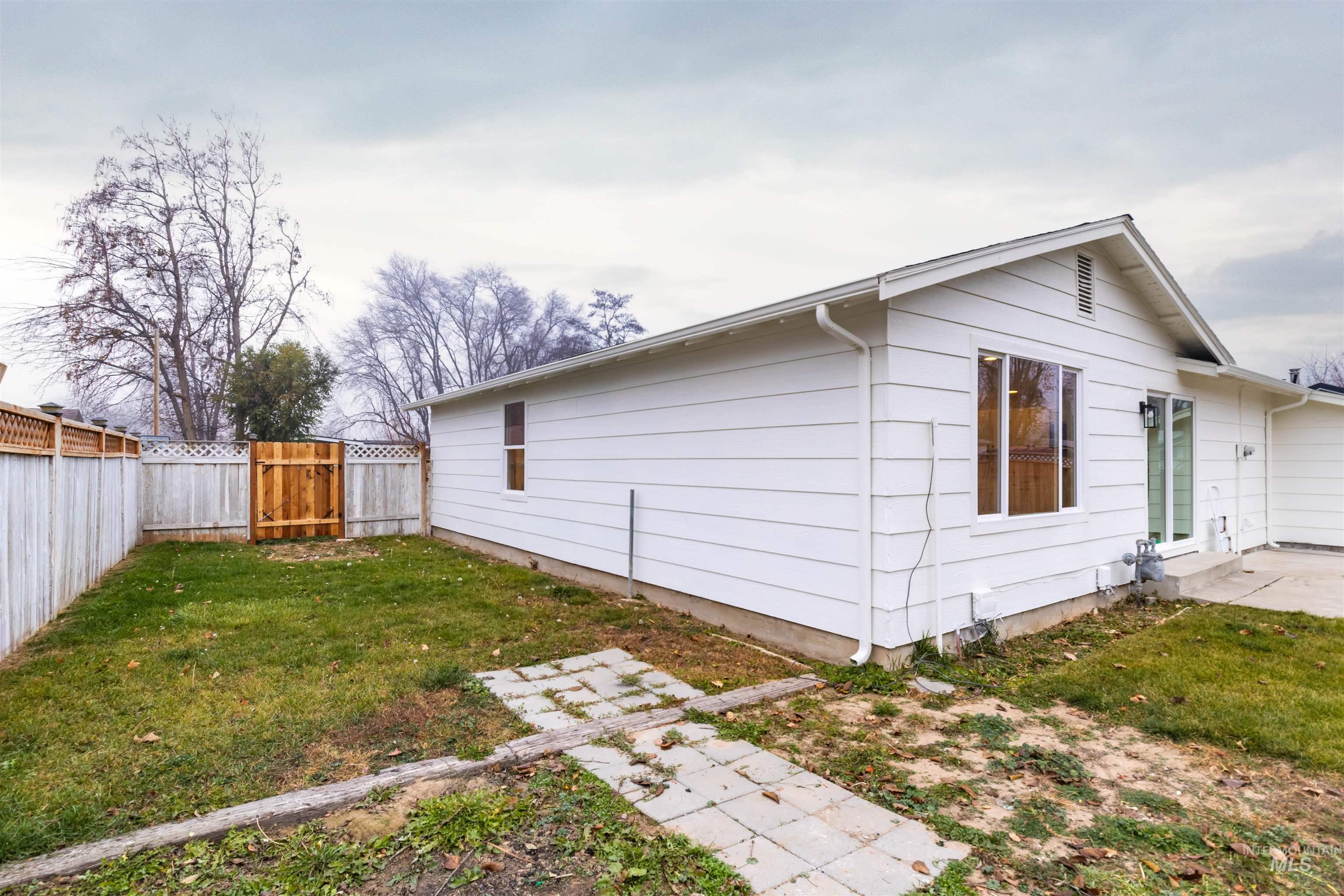 View of property exterior featuring a patio and a fenced backyard