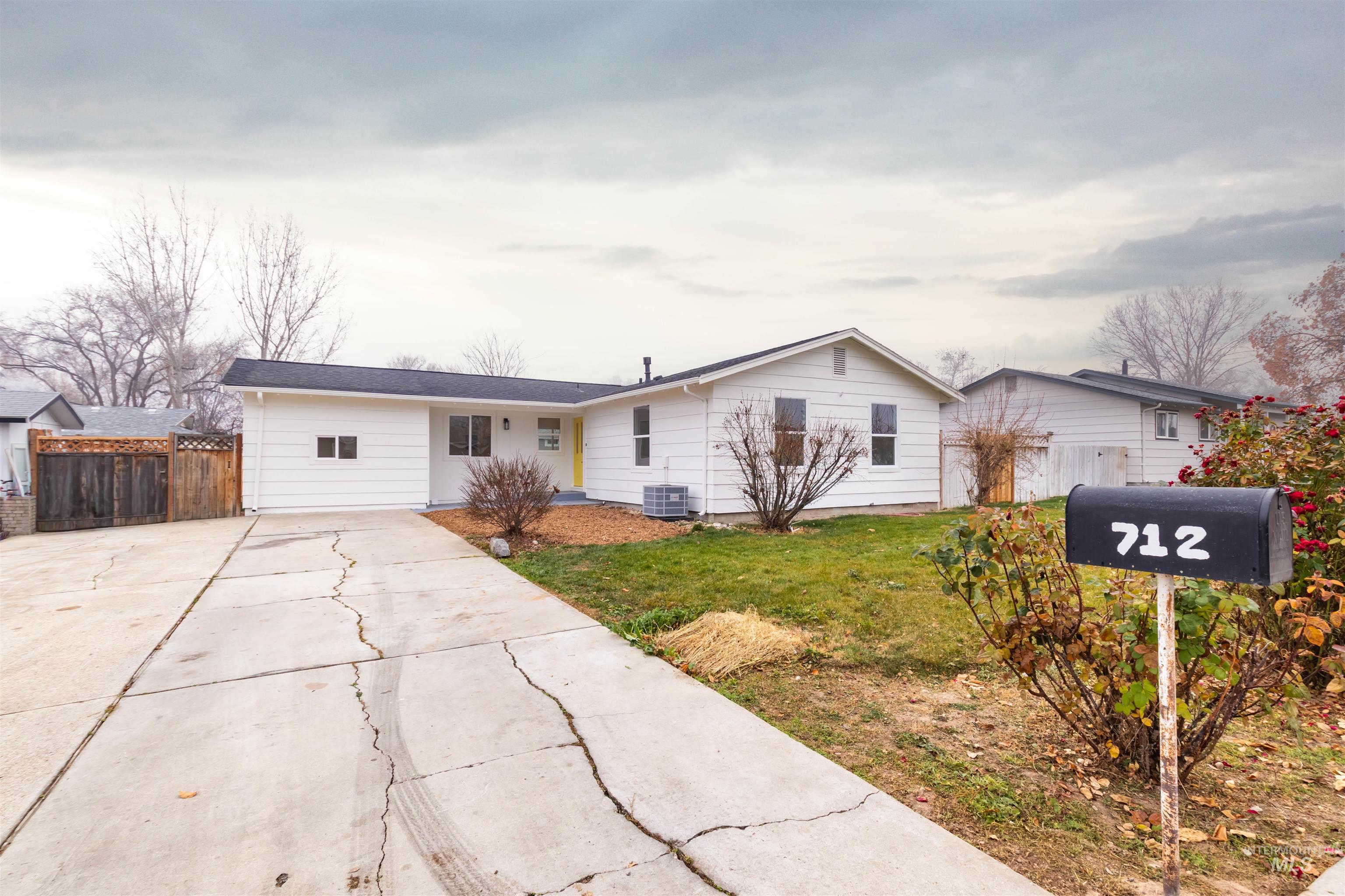 Ranch-style house with concrete driveway