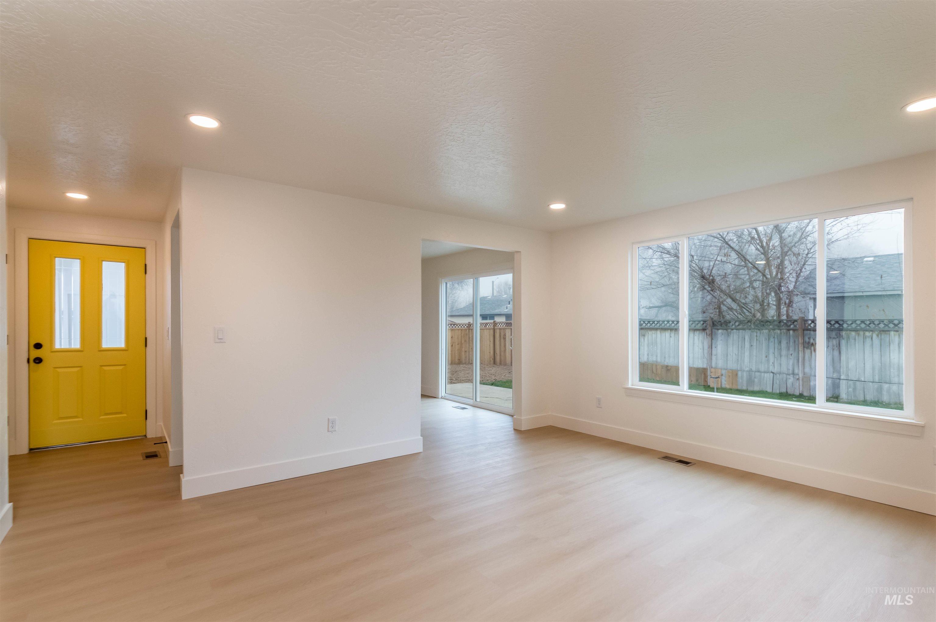 Unfurnished room featuring light wood finished floors, recessed lighting, and a textured ceiling