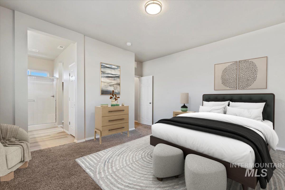 Bedroom with carpet flooring and ensuite bath