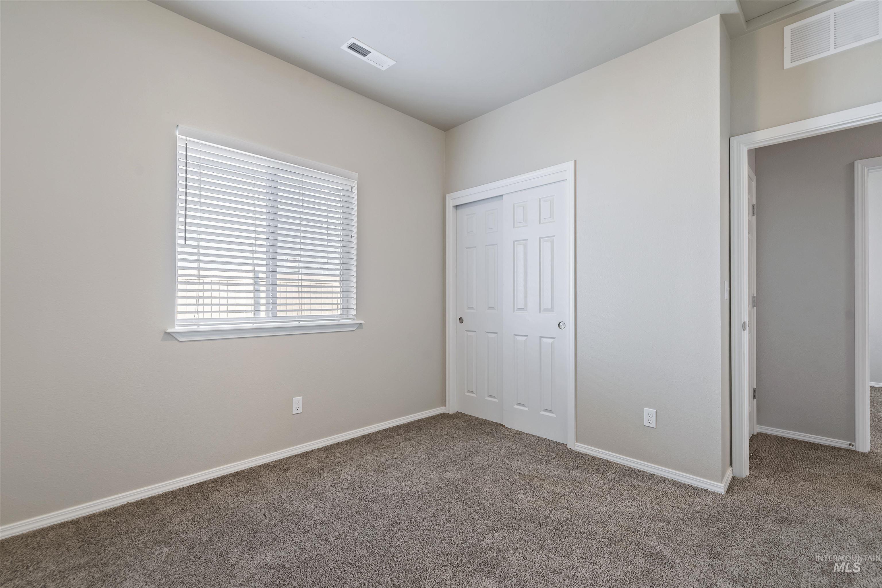 Unfurnished bedroom with carpet and a closet