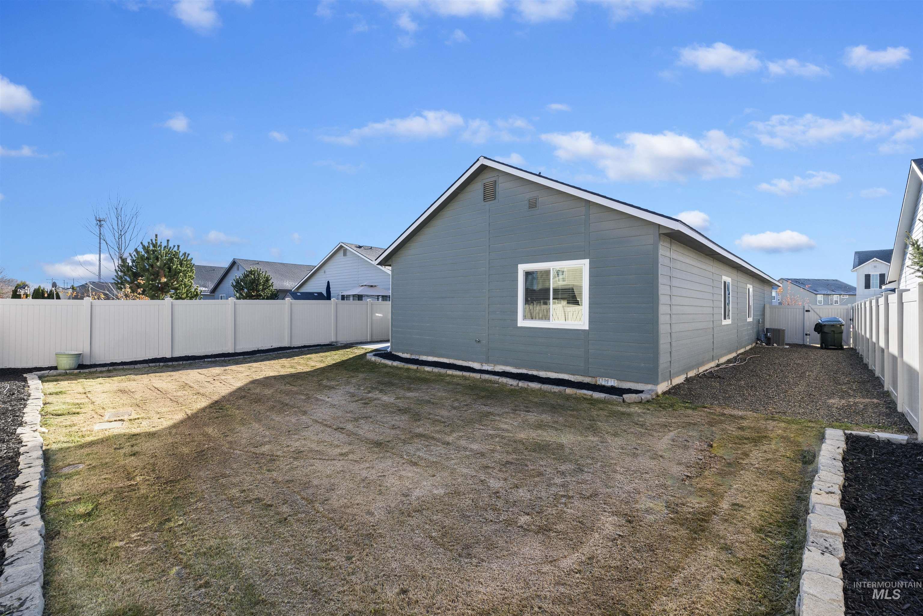 View of side of home with a fenced backyard
