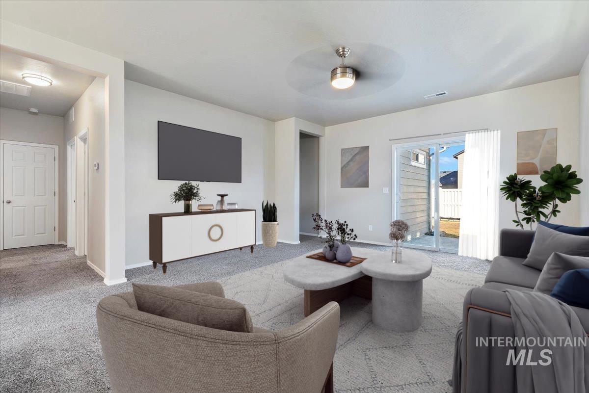 Living area featuring carpet flooring and ceiling fan