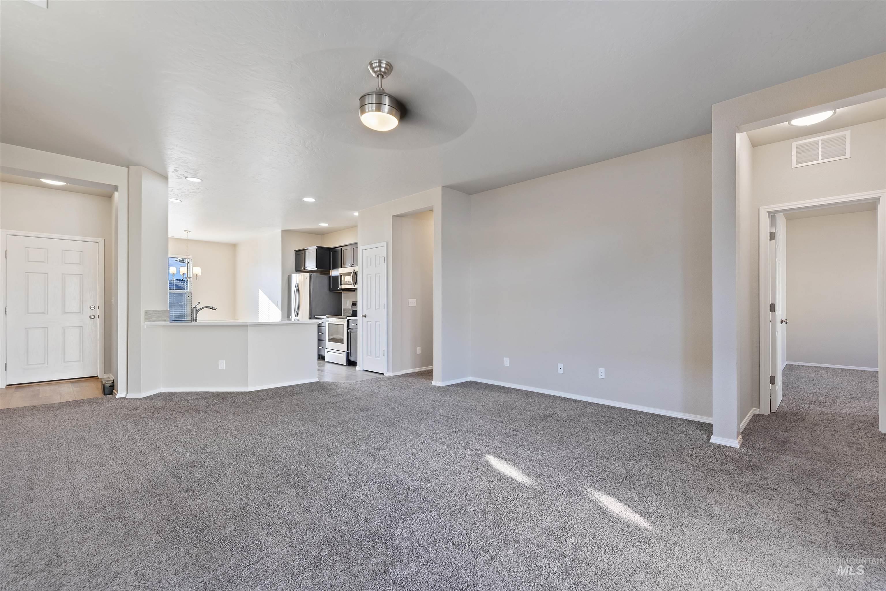 Unfurnished living room featuring carpet flooring, recessed lighting, and ceiling fan