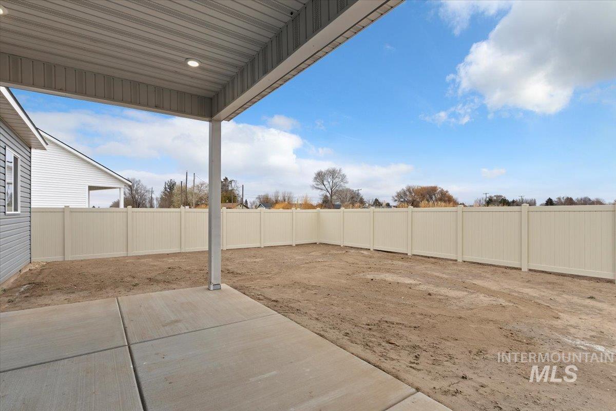 Fenced backyard featuring a patio