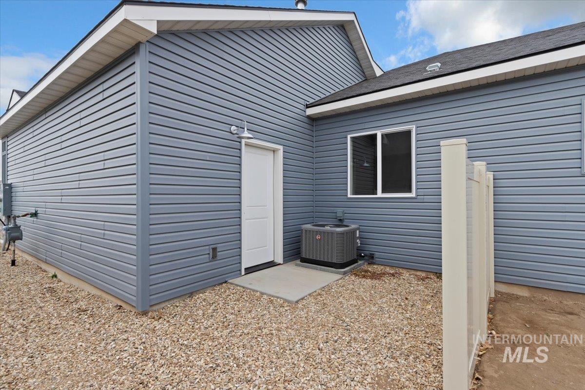 Rear view of property featuring a patio and roof with shingles