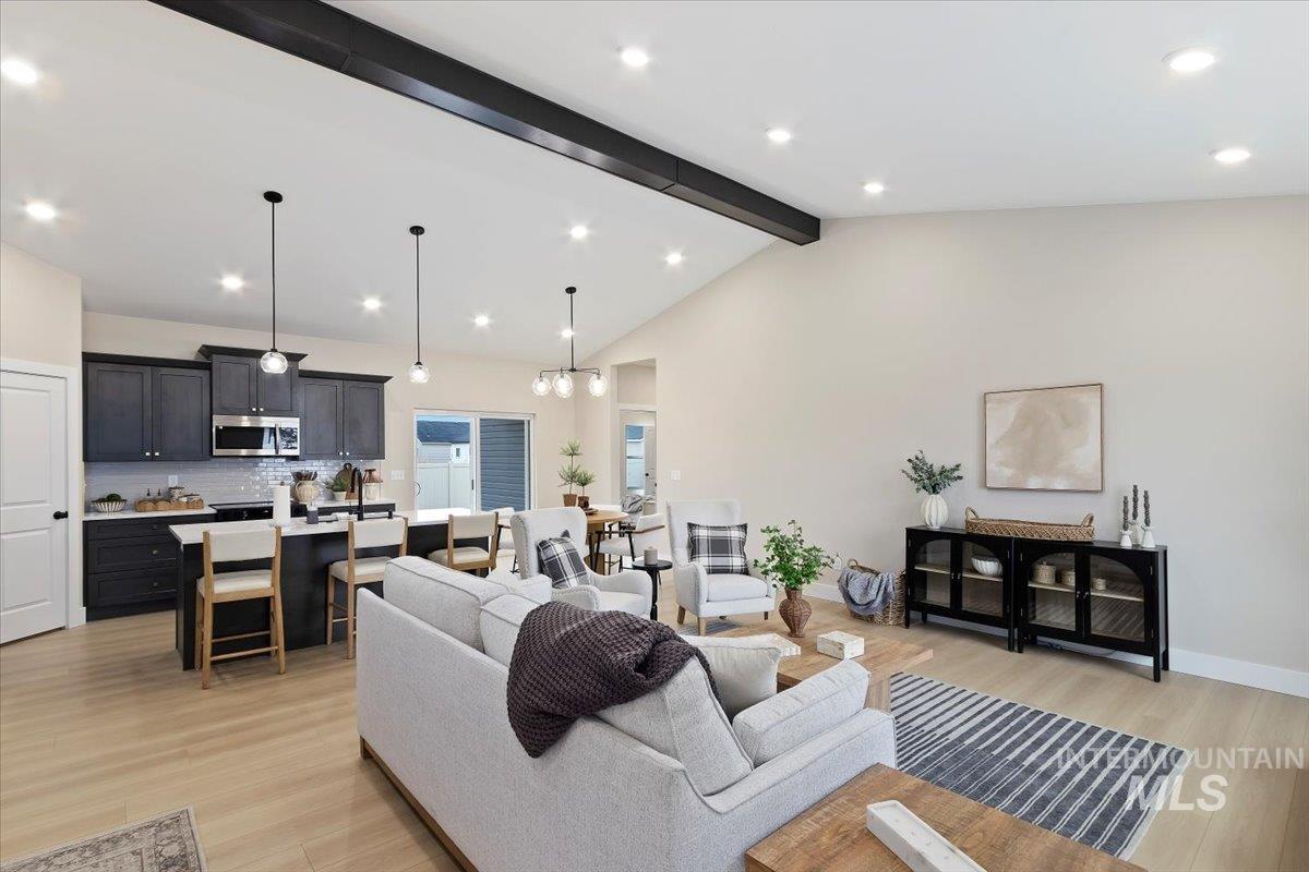 Living area with light wood-style floors, a chandelier, and recessed lighting