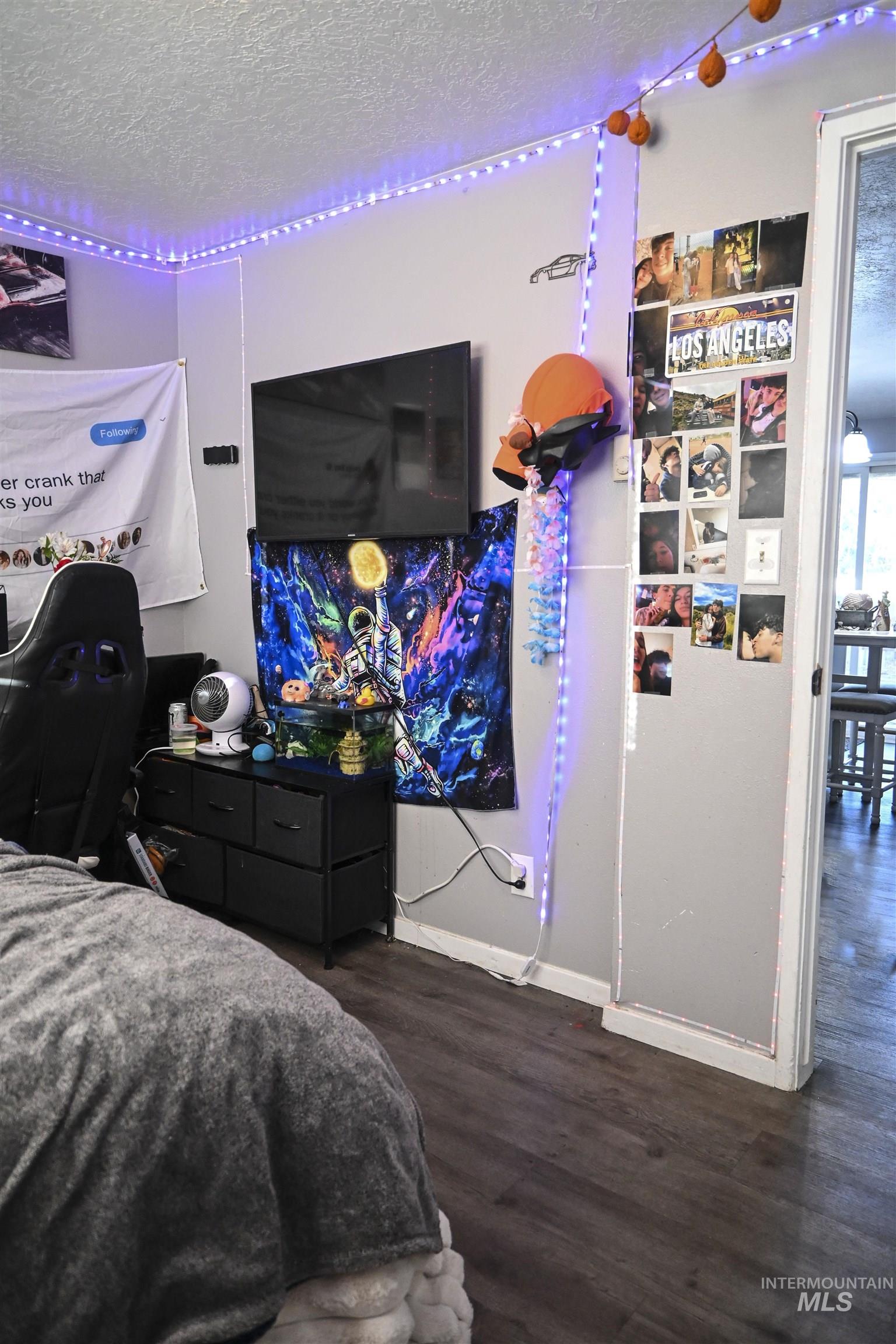 Bedroom featuring a textured ceiling and dark wood-type flooring