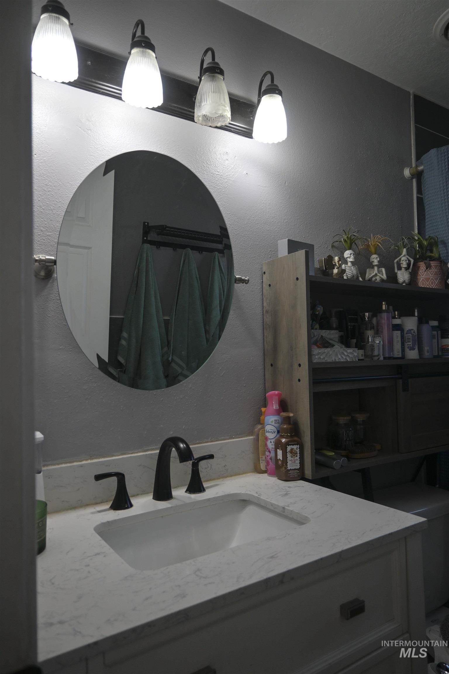 Bathroom featuring vanity and a textured wall