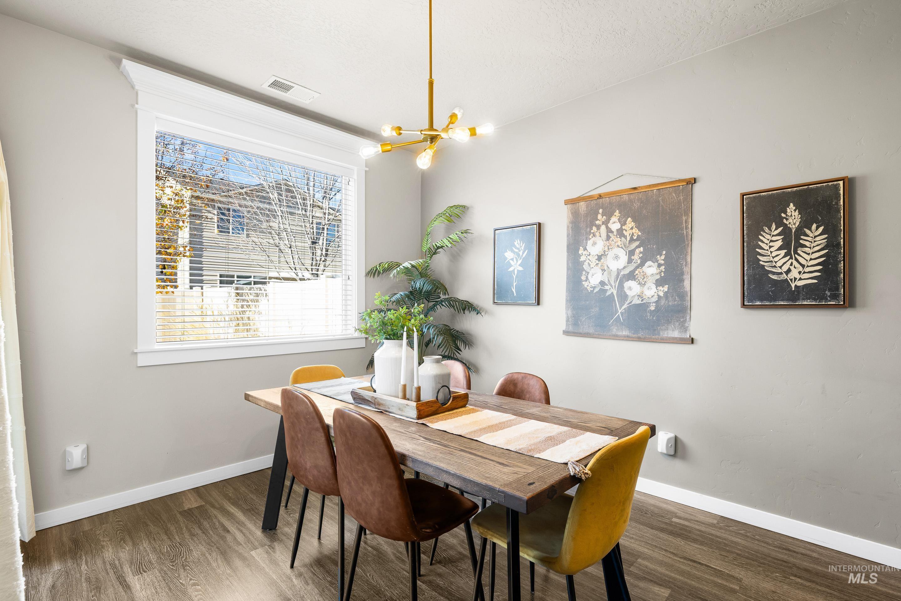 Dining area featuring wood finished floors and a chandelier