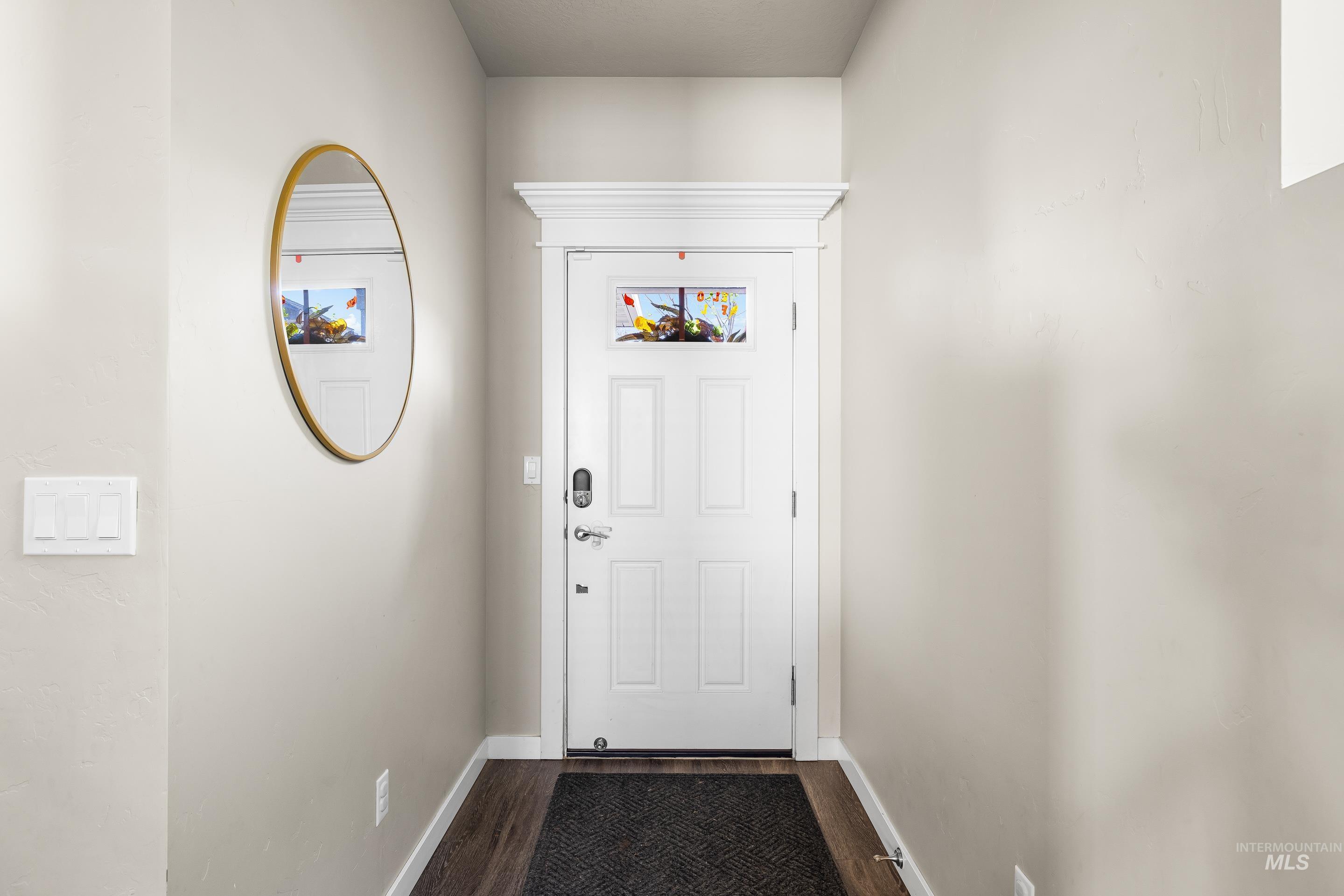 Entryway featuring wood finished floors and baseboards
