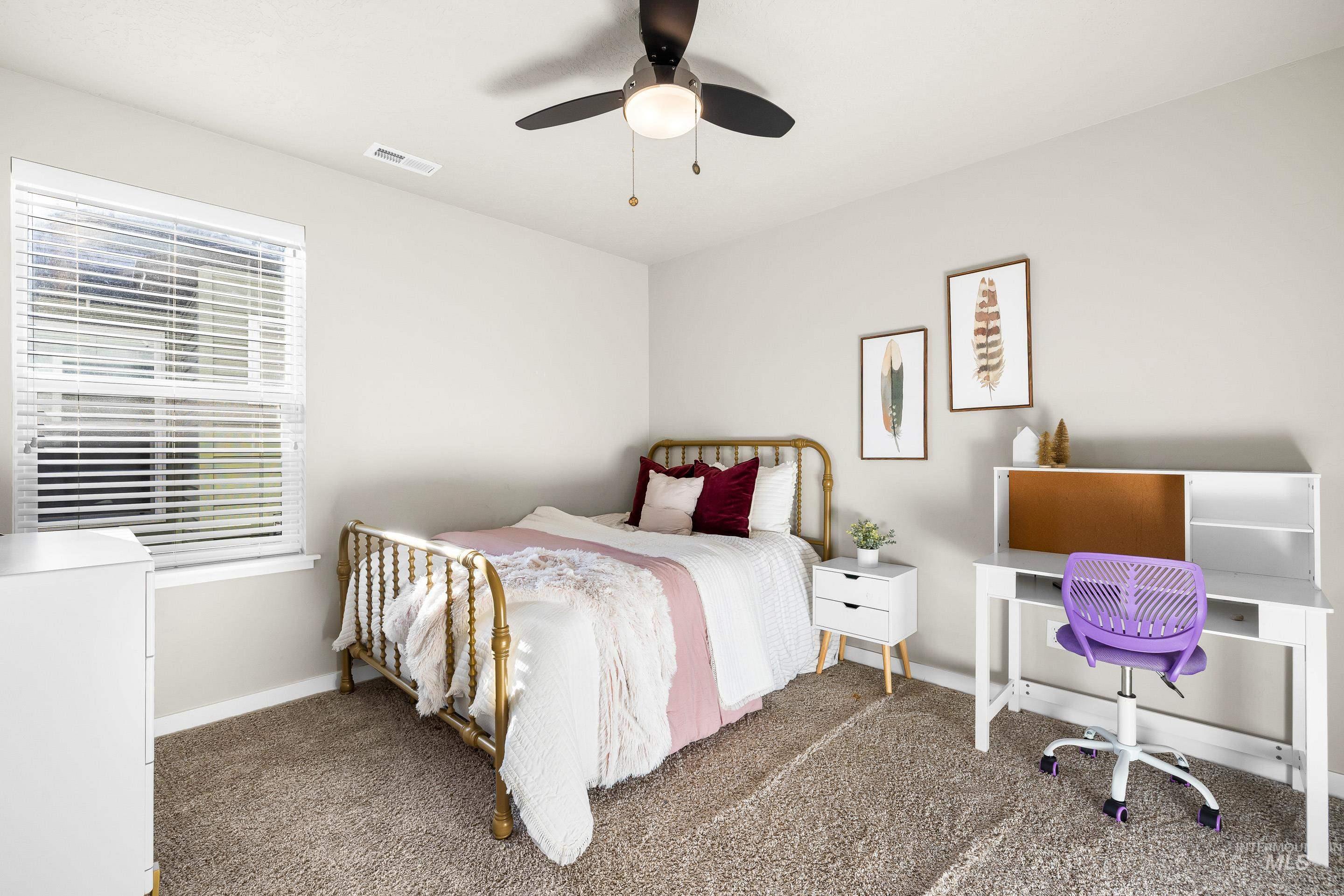 Bedroom featuring carpet floors, a ceiling fan, and a desk
