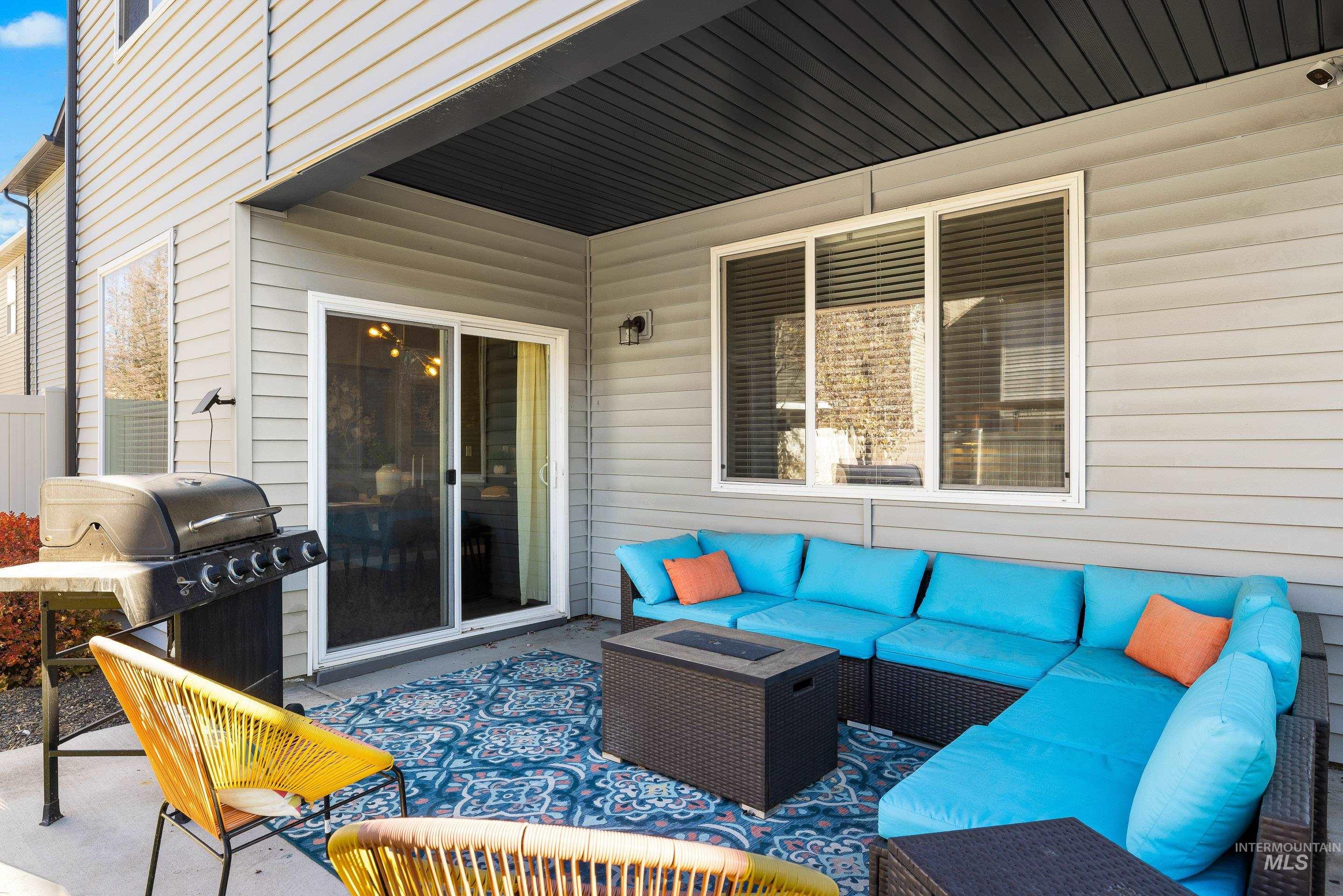 View of patio with grilling area and an outdoor living space