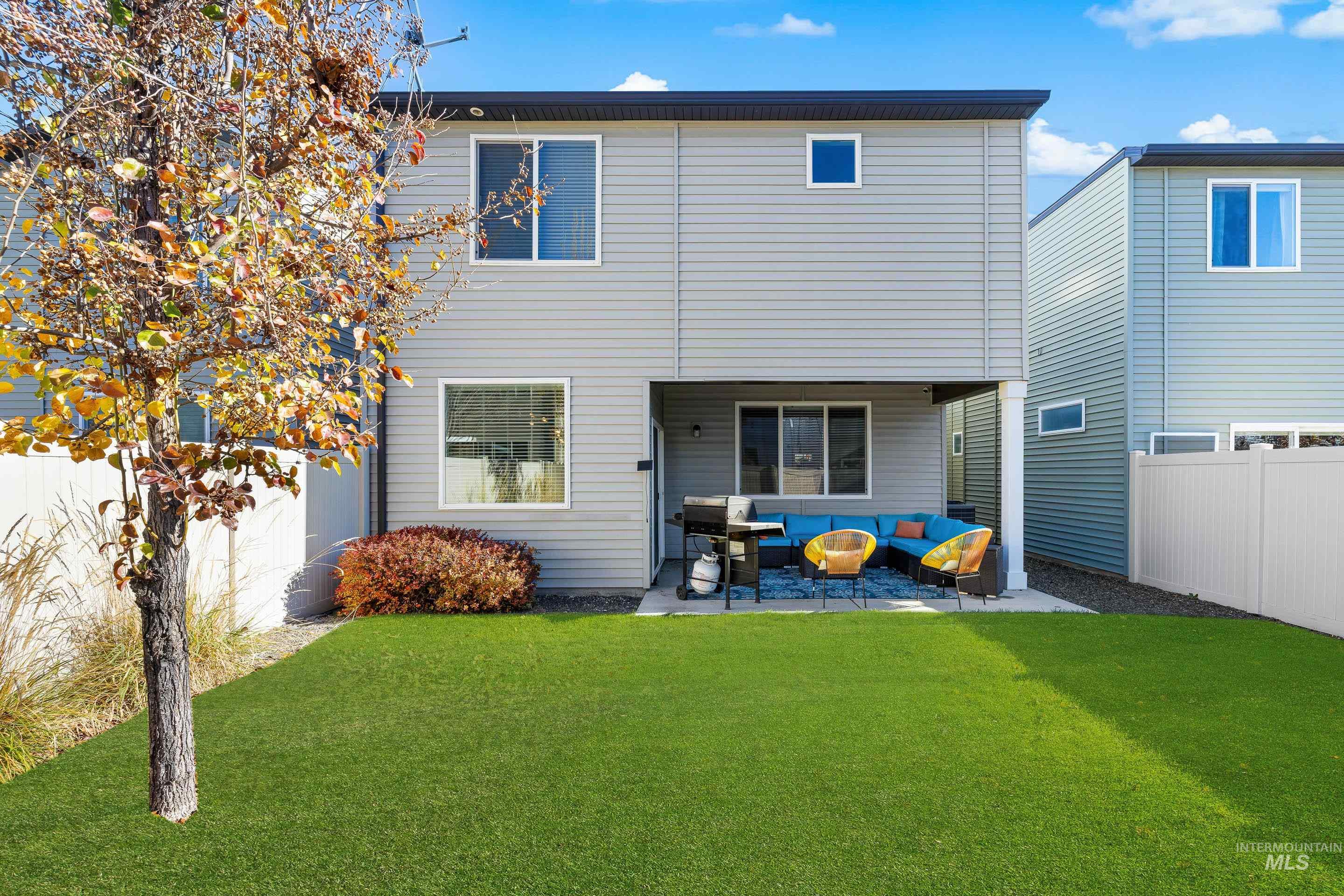 Back of property featuring an outdoor hangout area and a patio