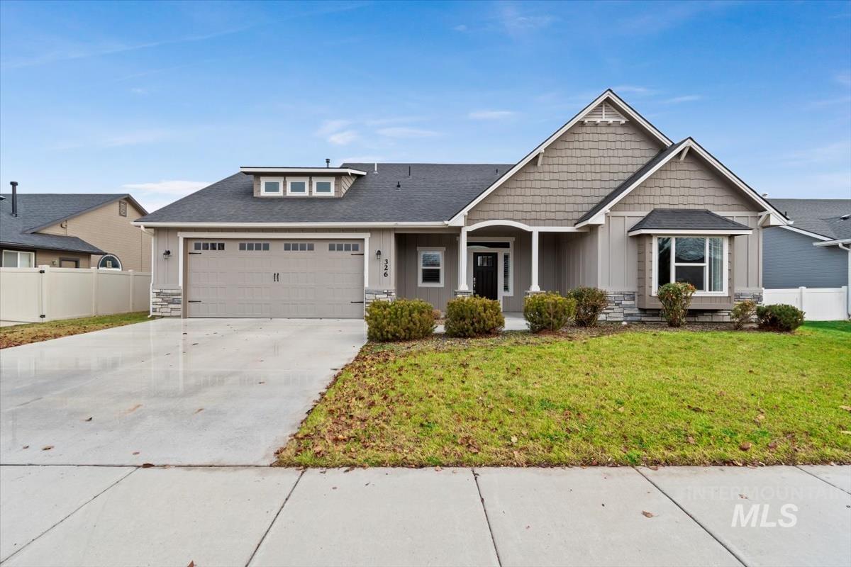 Craftsman inspired home with stone siding, concrete driveway, board and batten siding, an attached garage, and roof with shingles