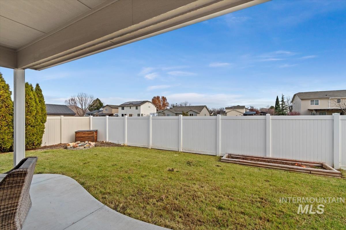 Fenced backyard with a residential view and a patio