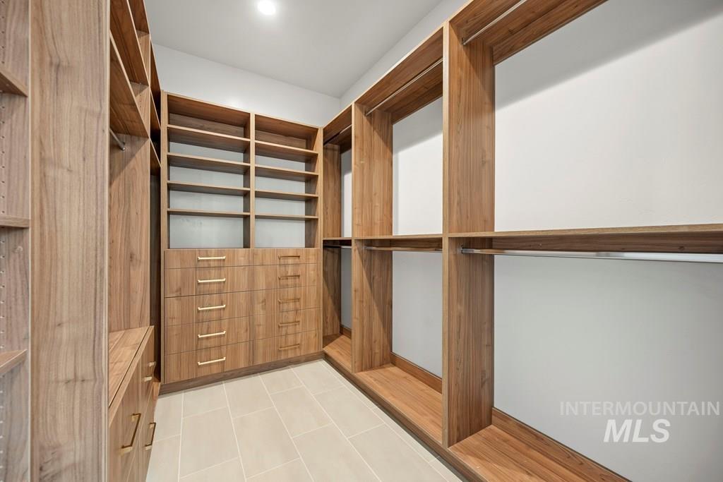 Spacious closet with light tile patterned floors