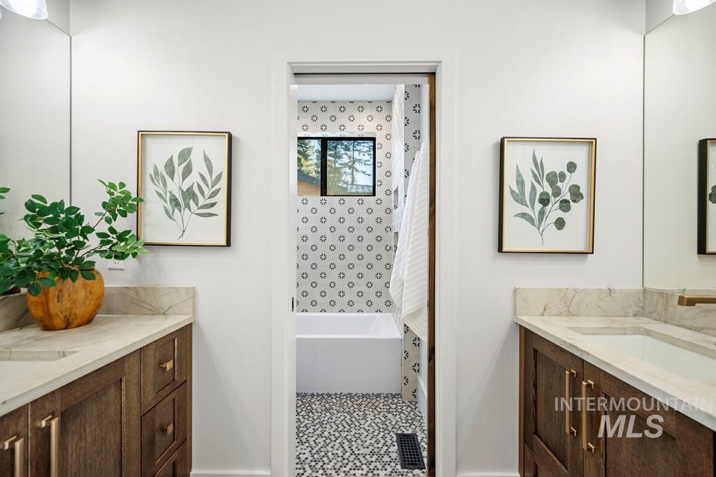Full bathroom featuring two vanities and shower / tub combo - Second Floor