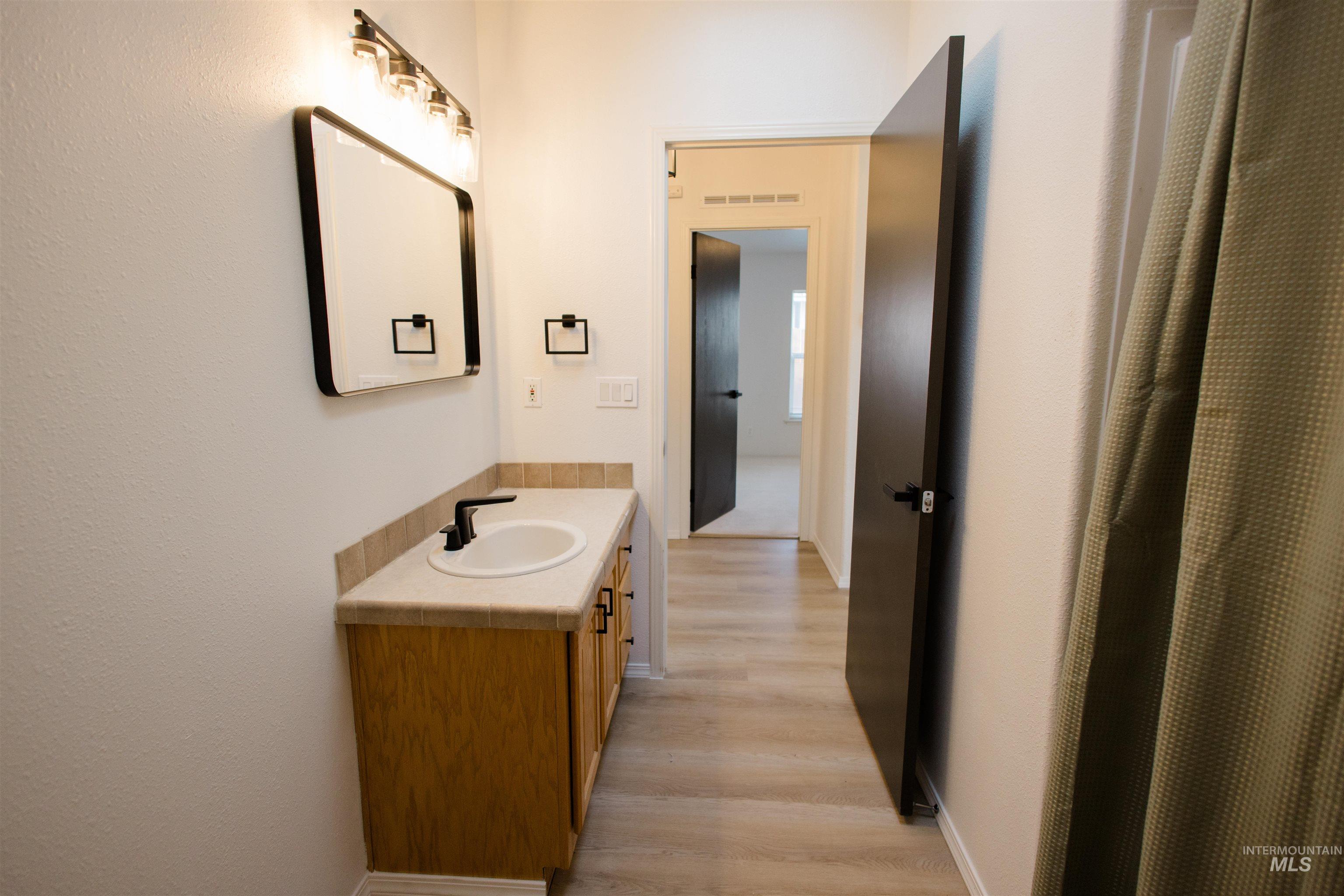 Bathroom with vanity and light wood-style floors
