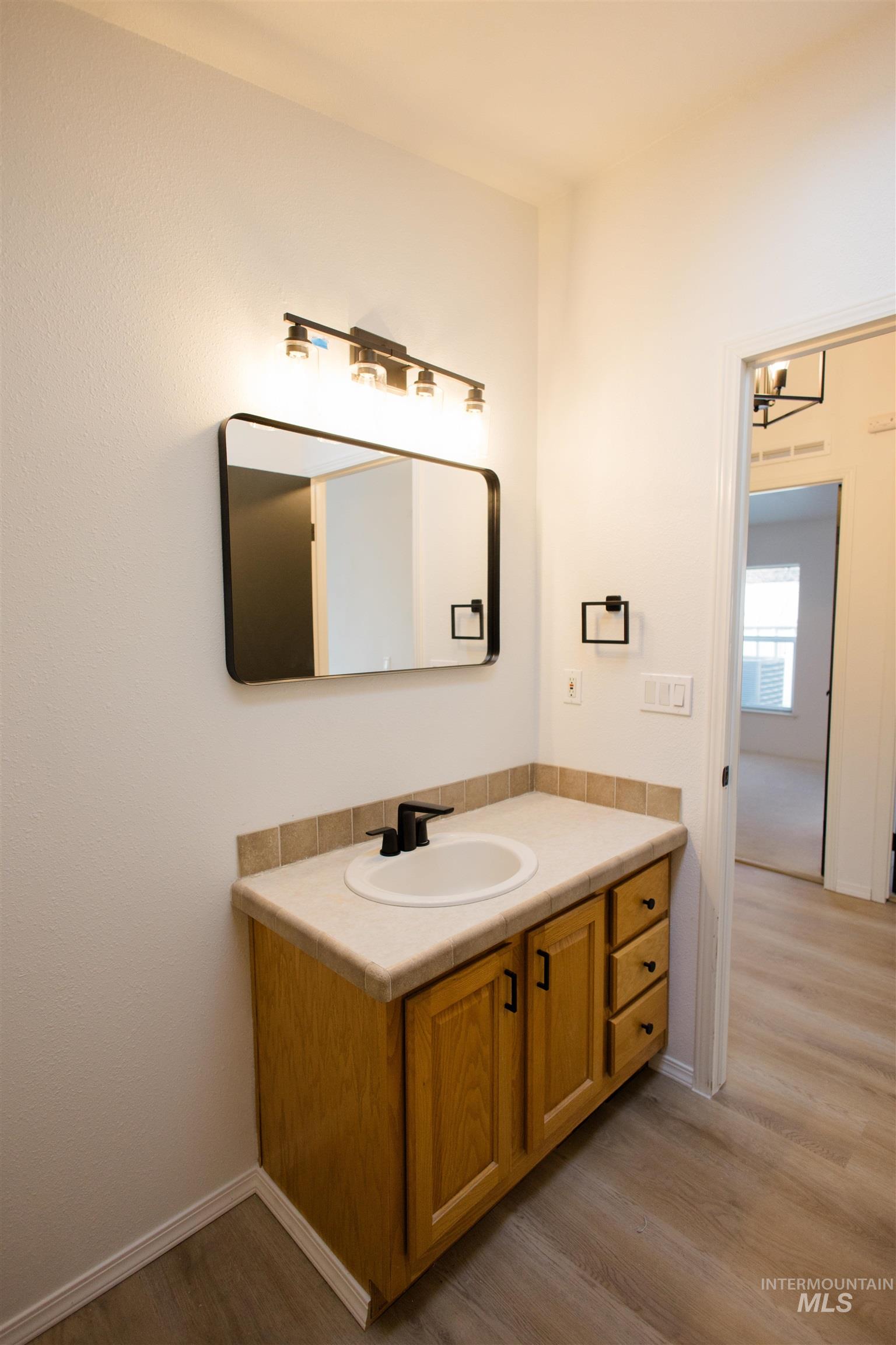 Bathroom with vanity and light wood-type flooring