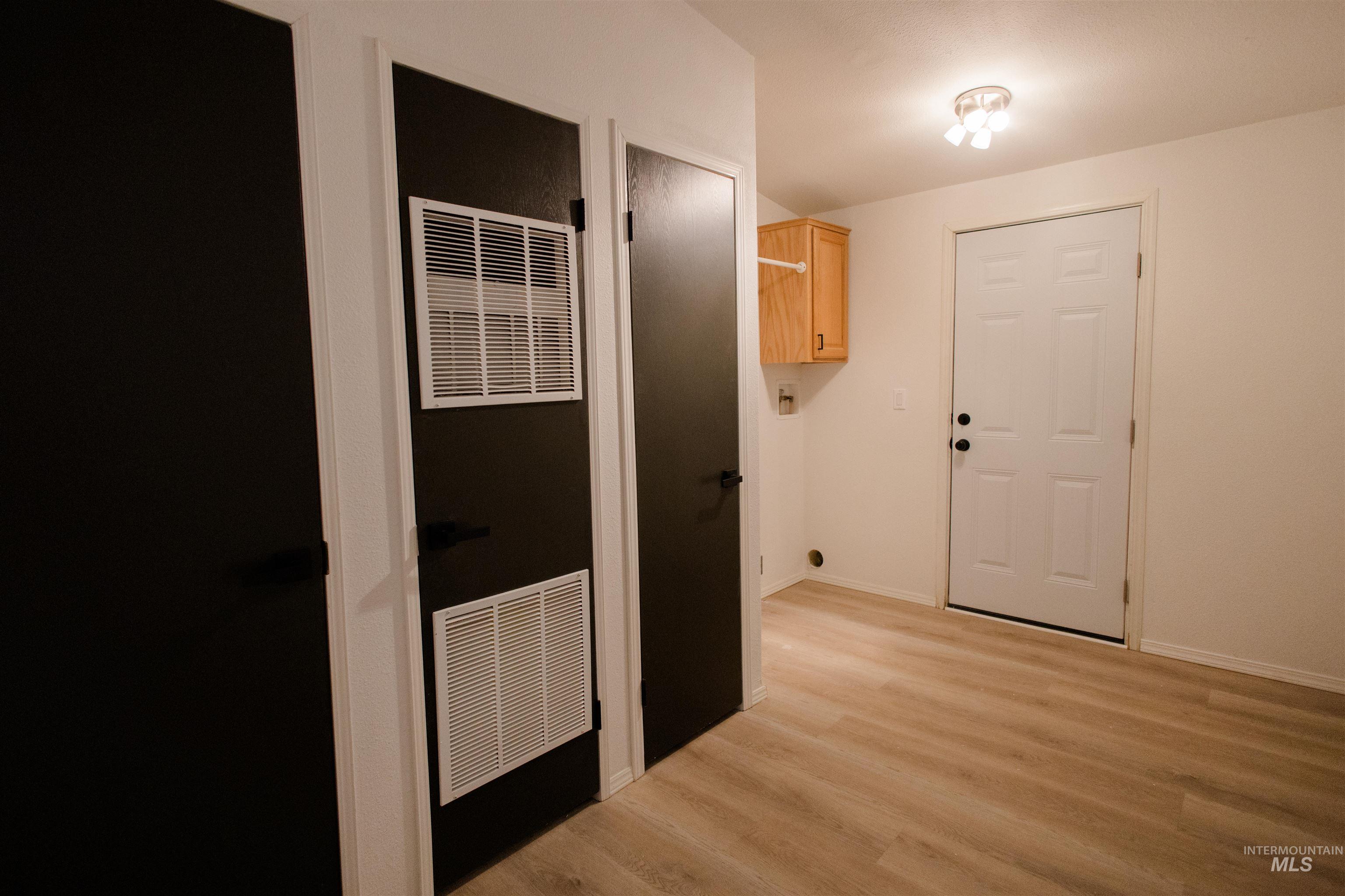 Hall featuring a heating unit and light wood-type flooring