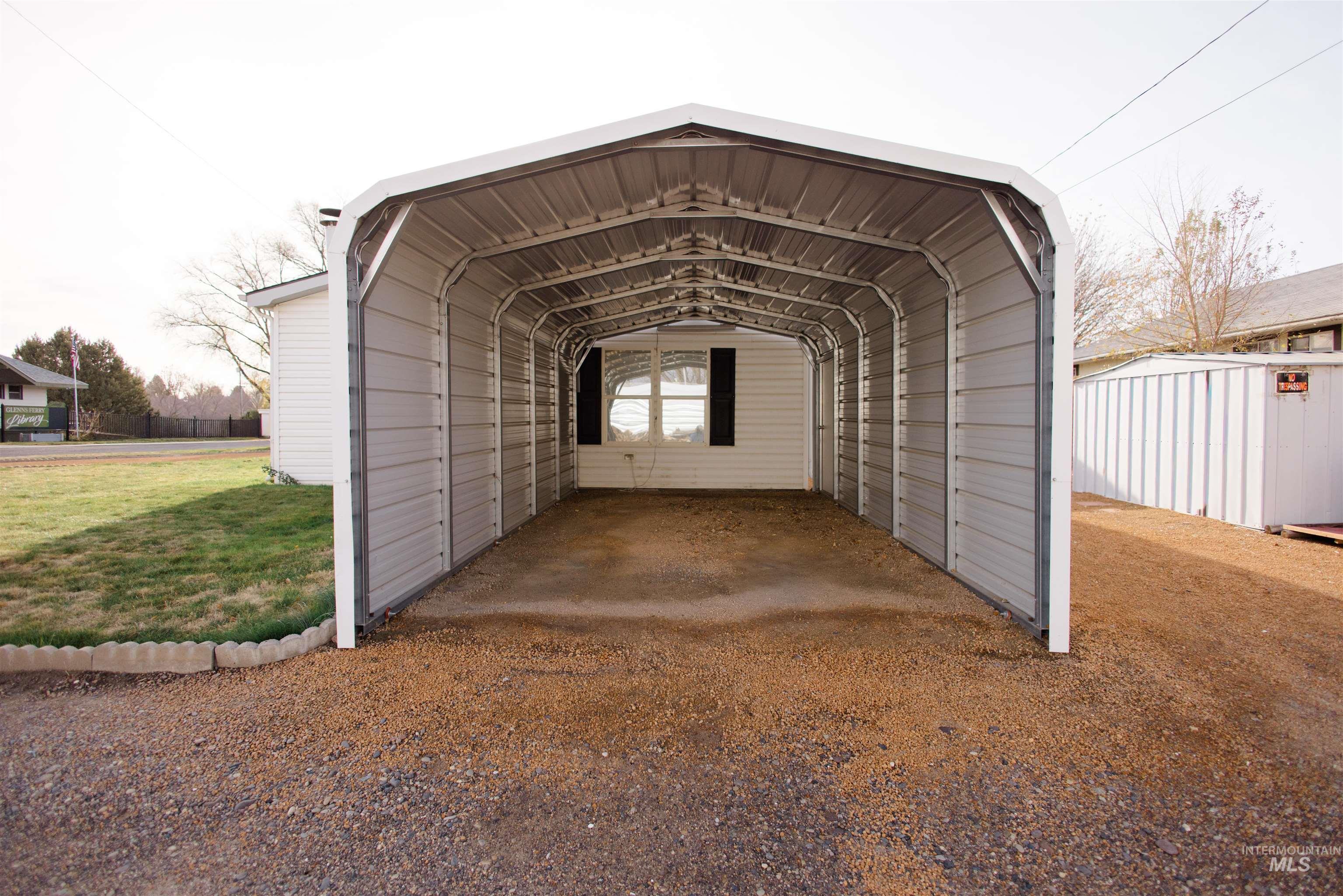 View of vehicle parking featuring a carport