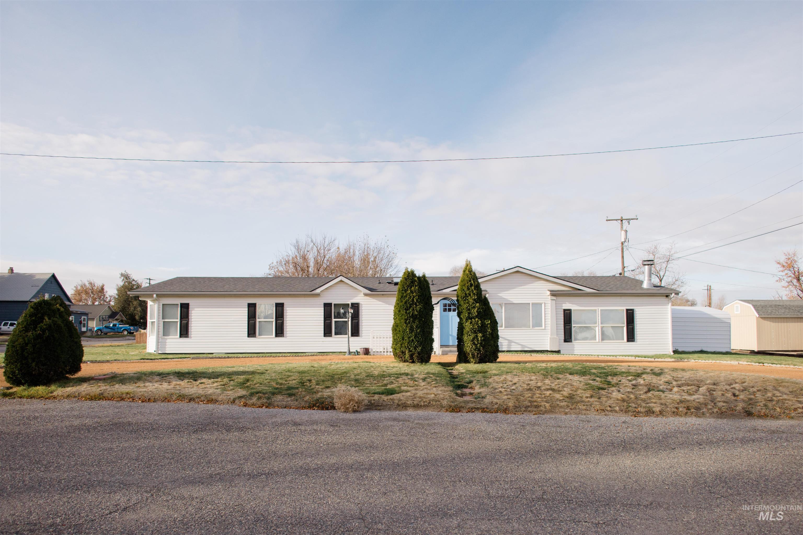 Ranch-style home featuring a front lawn