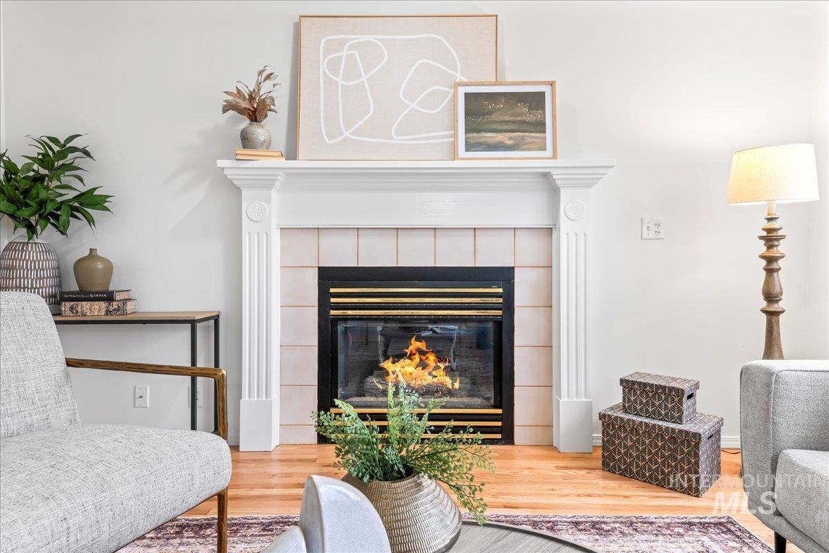 Living area with a tile fireplace and wood finished floors