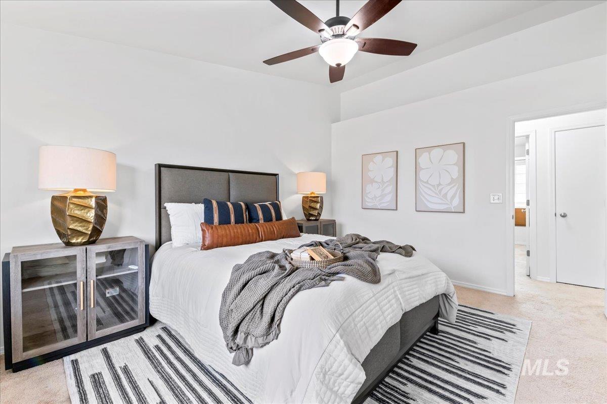 Bedroom featuring light carpet and a ceiling fan