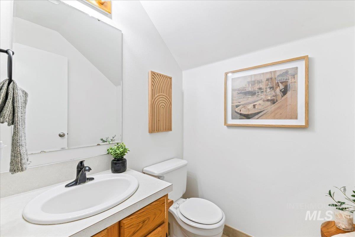 Bathroom featuring vanity and lofted ceiling