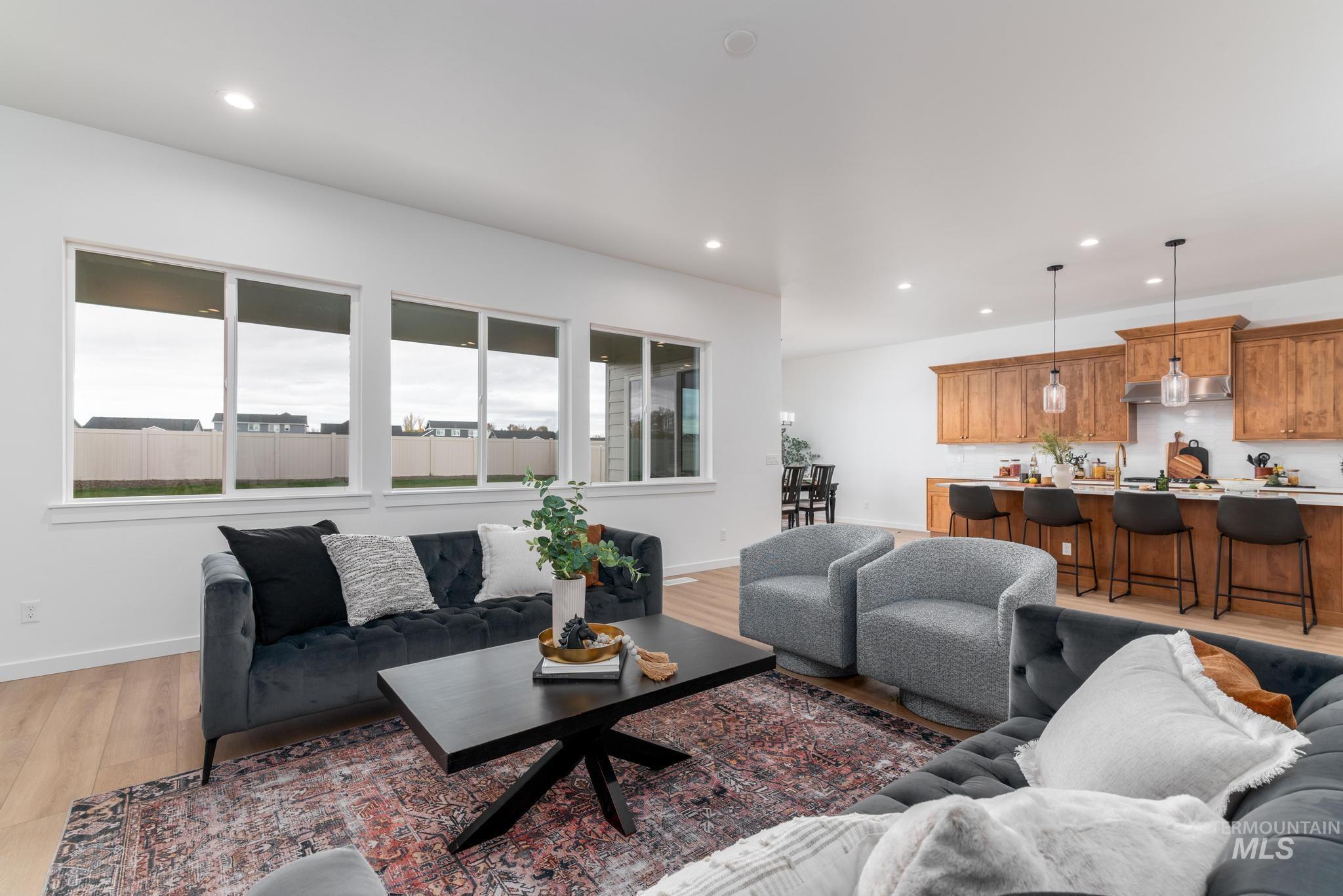 Living room with recessed lighting and light wood finished floors