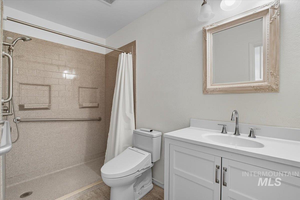 Full bathroom with a stall shower and vanity