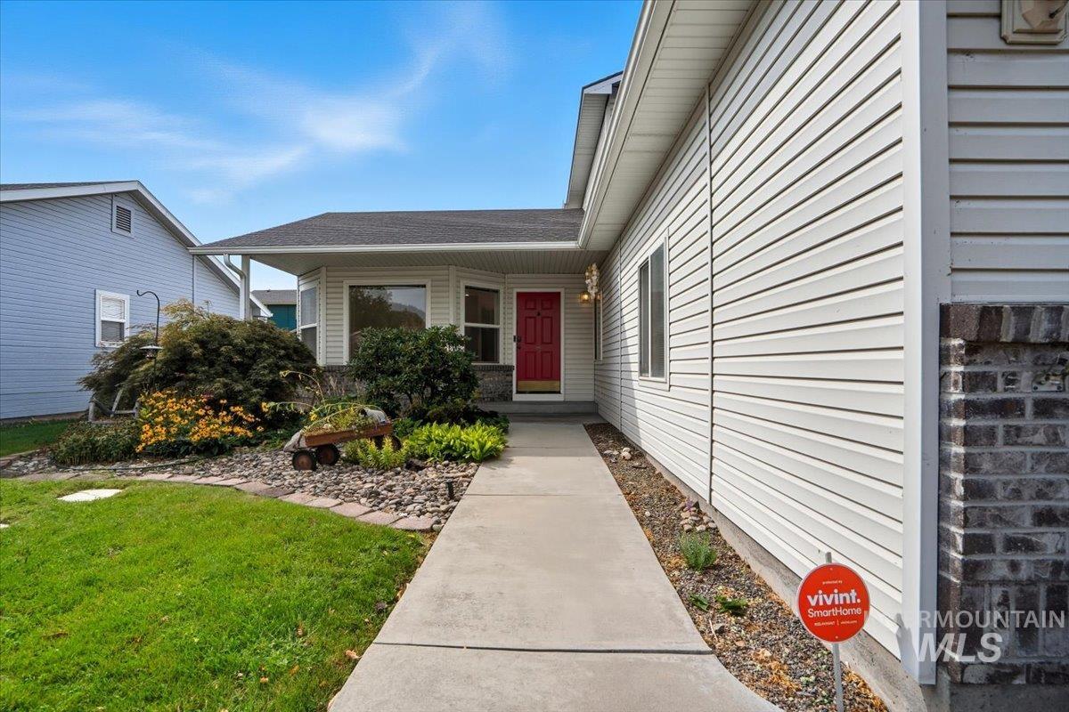 Property entrance with a yard and covered porch