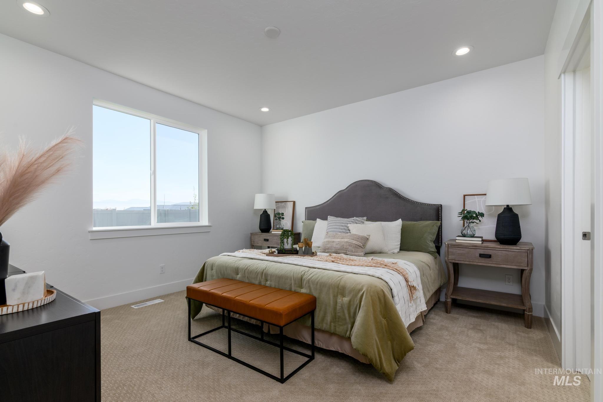 Bedroom featuring light carpet and recessed lighting