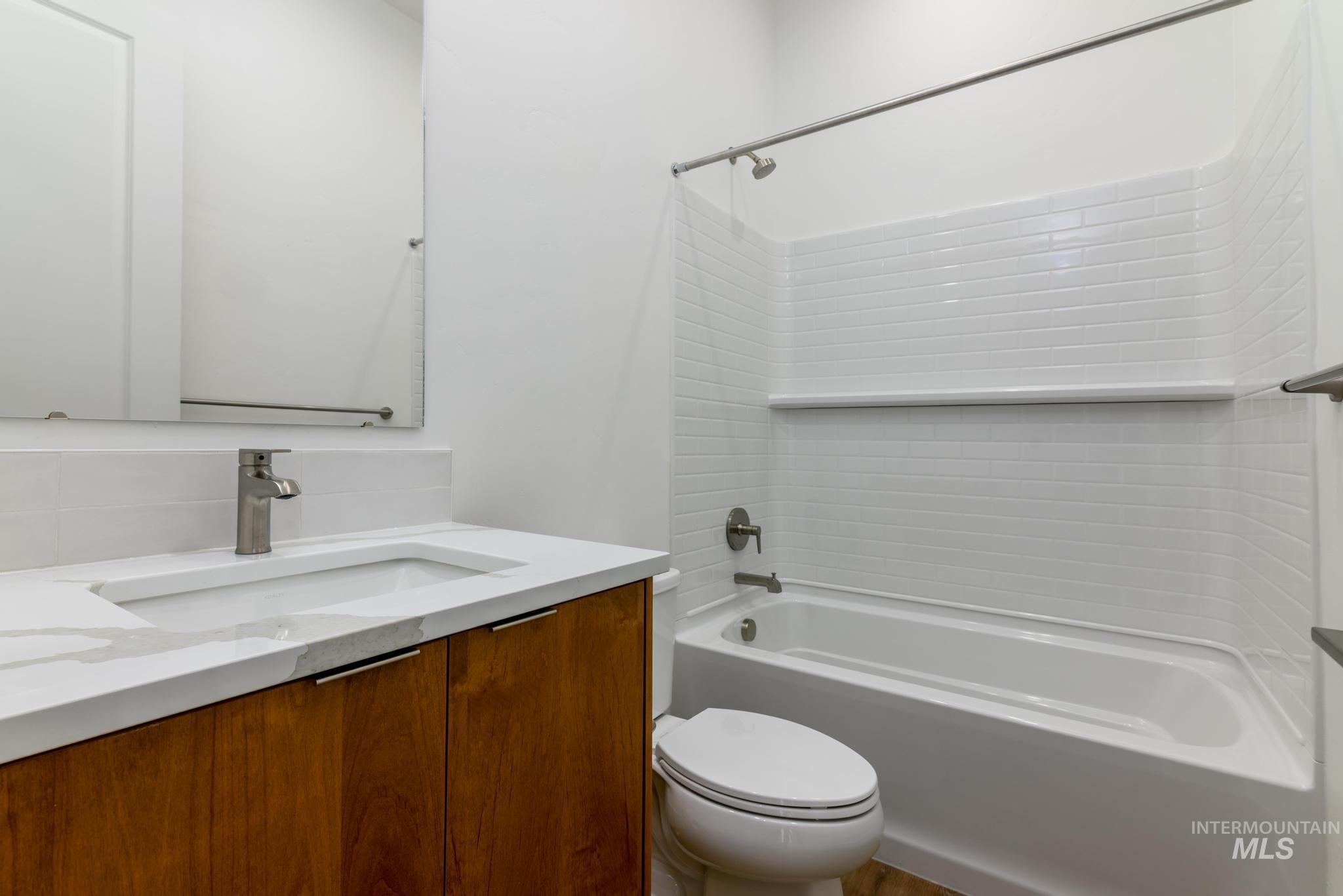 Bathroom featuring vanity and shower / bathtub combination