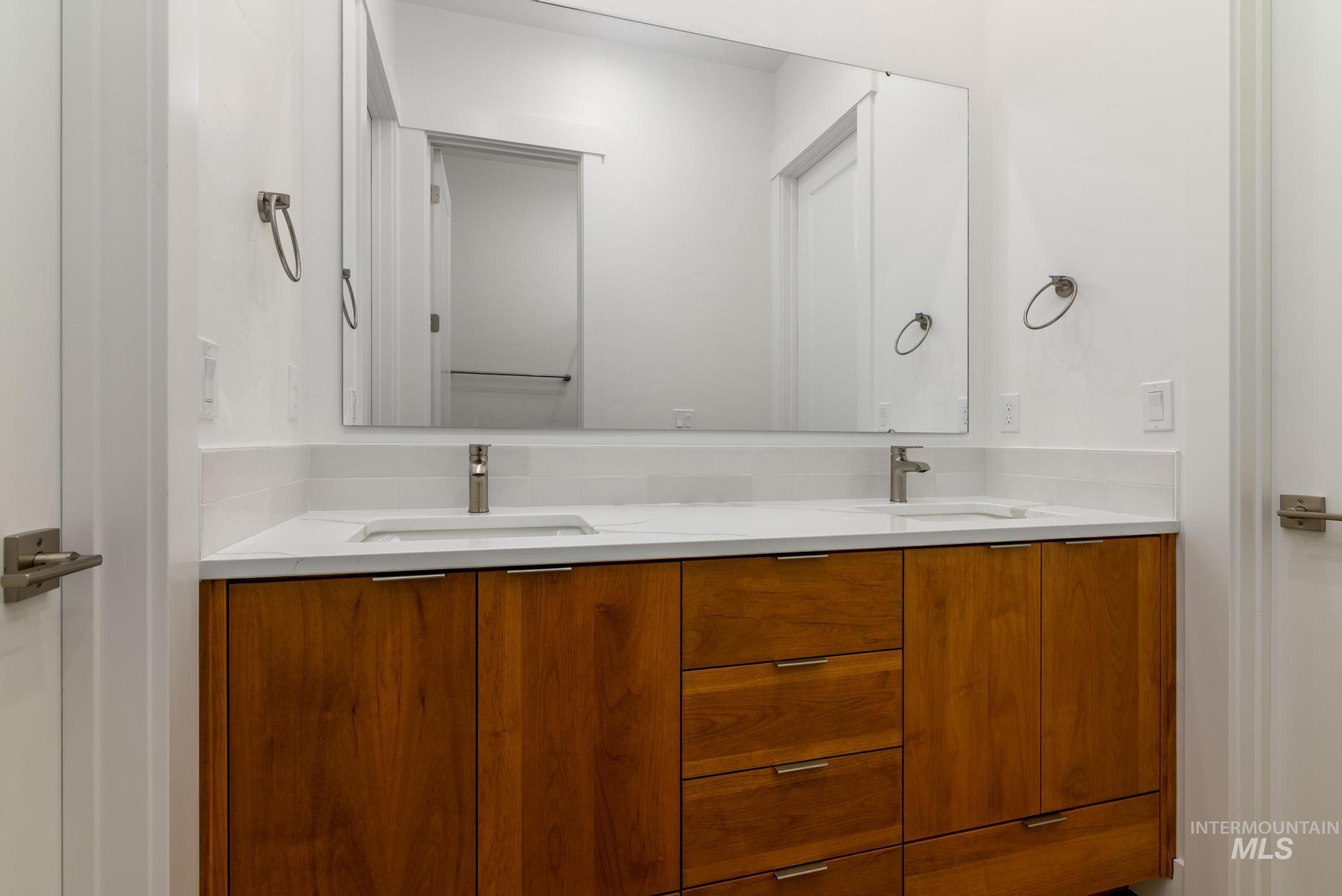 Full bath featuring double vanity