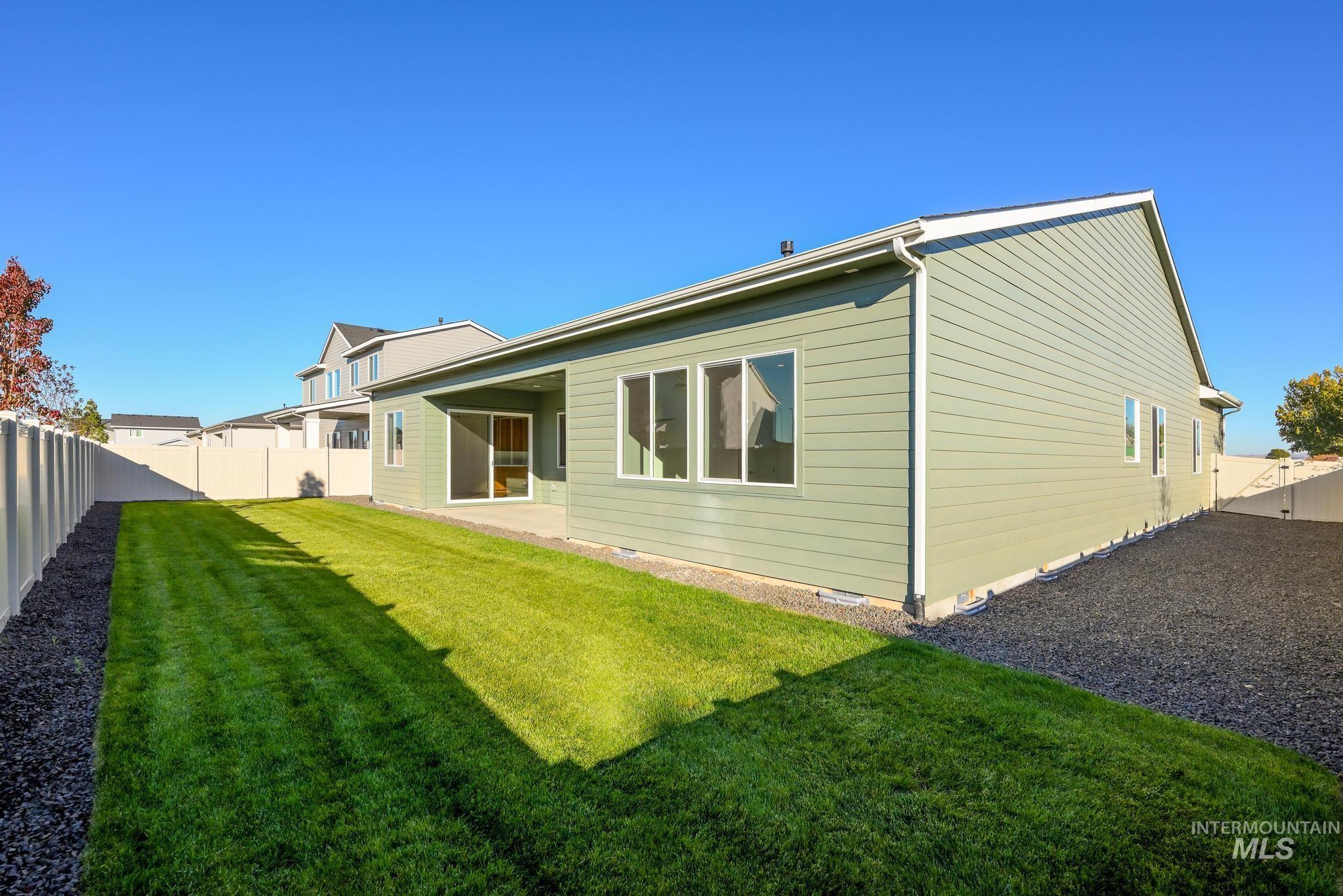 Rear view of property featuring a fenced backyard, a patio area, and crawl space