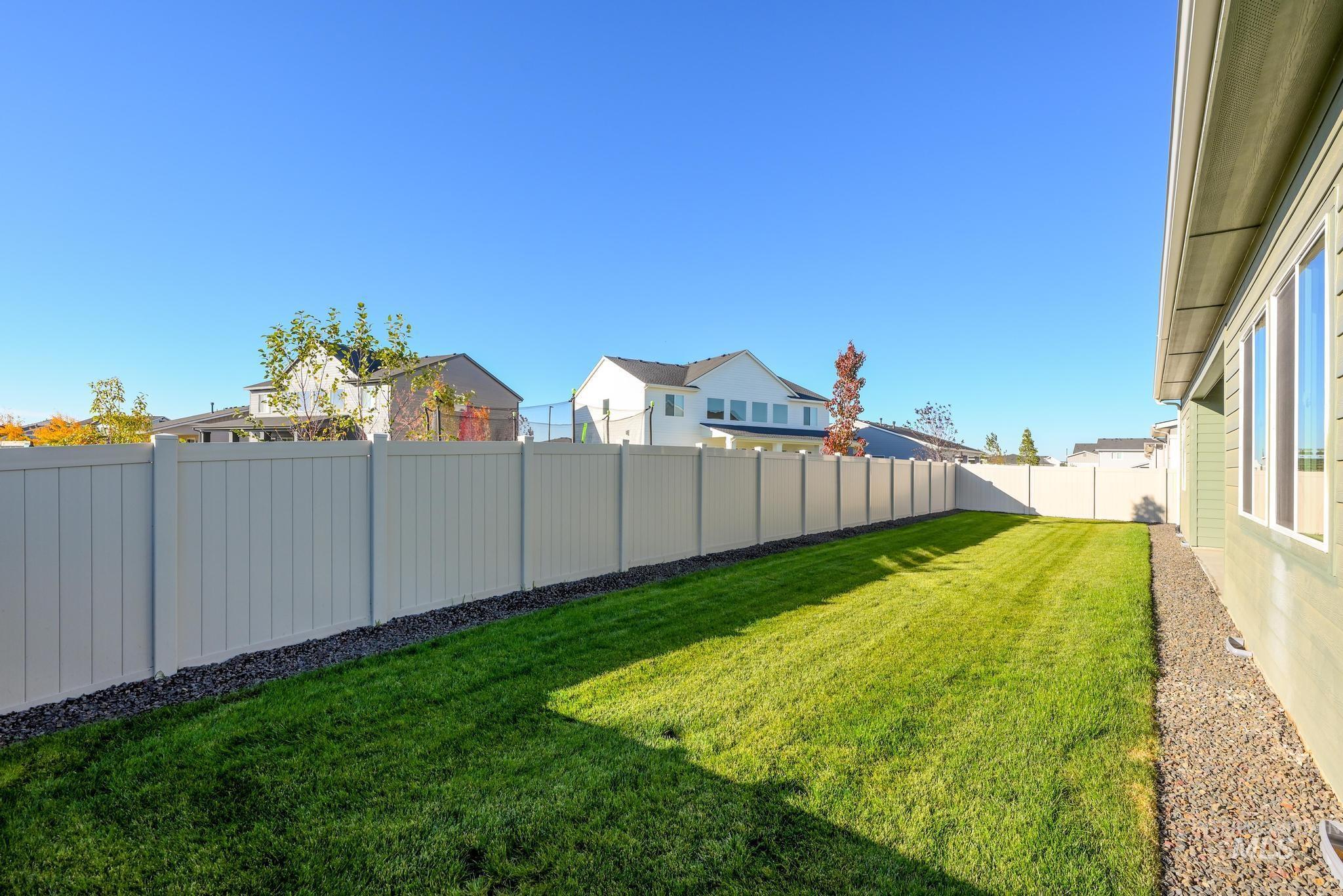 Fenced backyard with a residential view