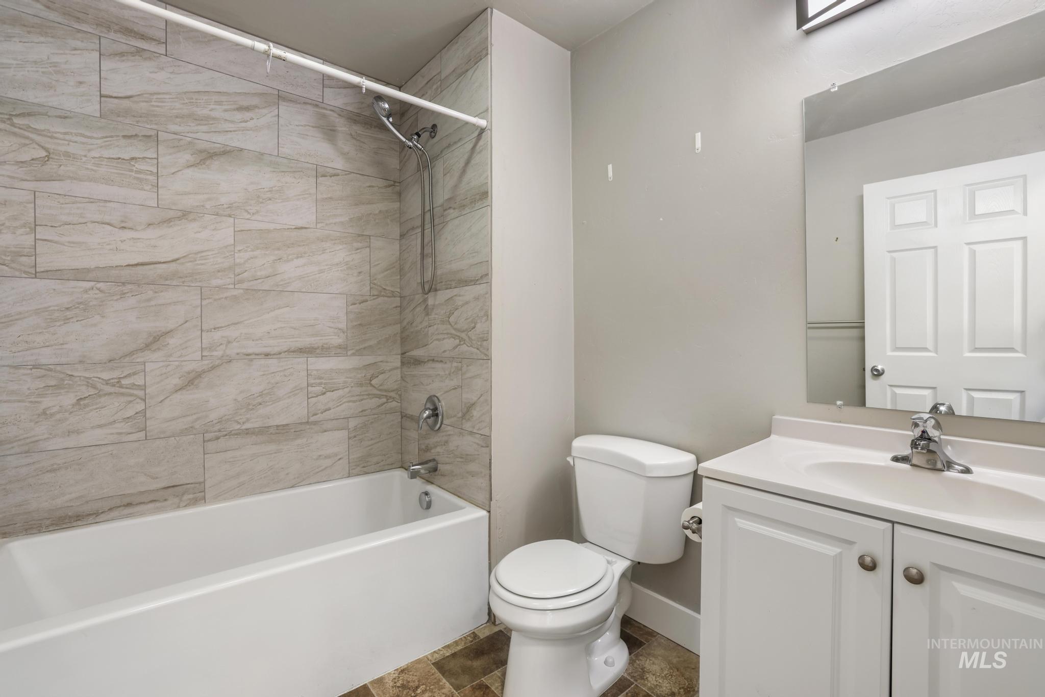 Bathroom featuring vanity and  shower combination
