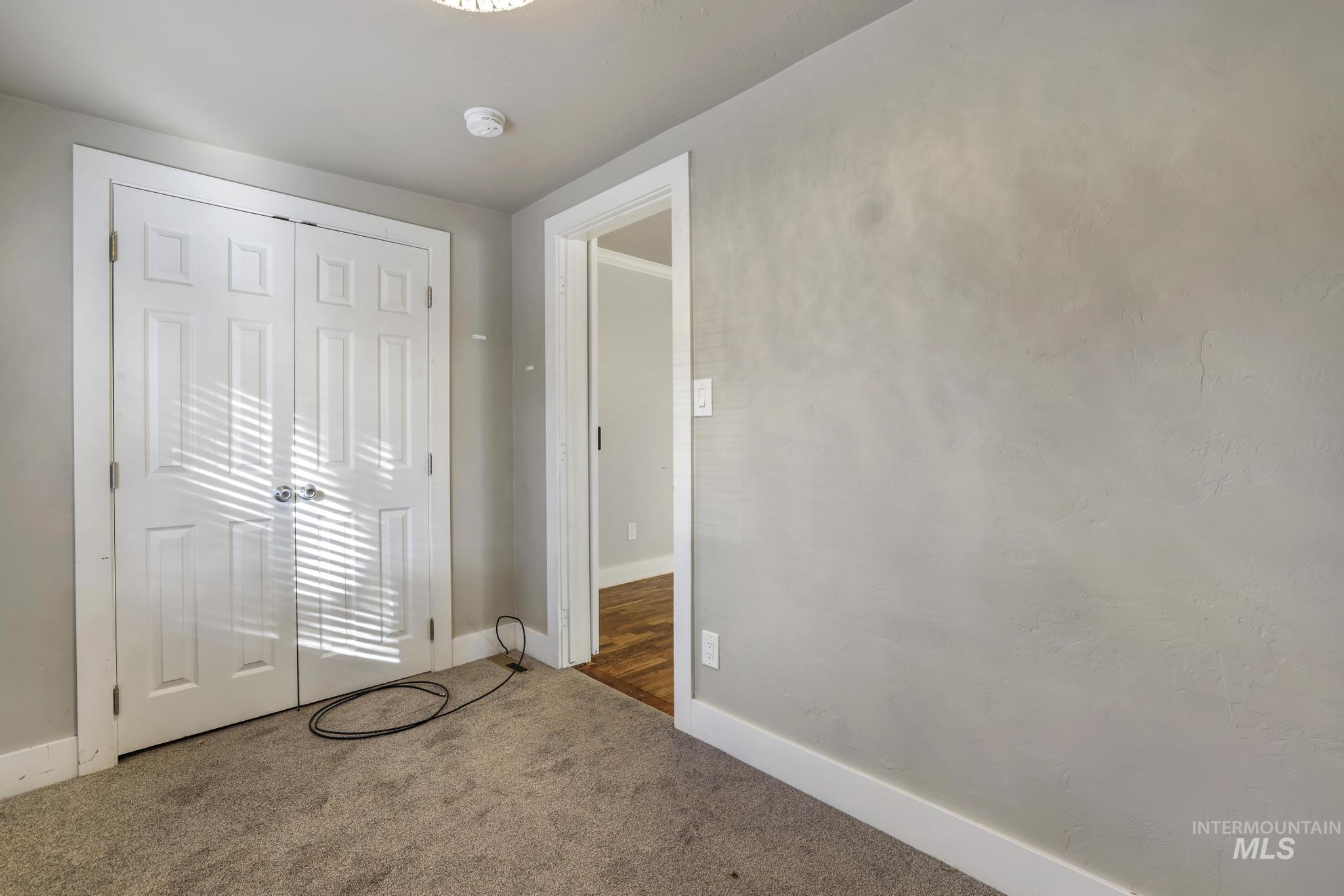 Unfurnished bedroom with carpet floors and a closet