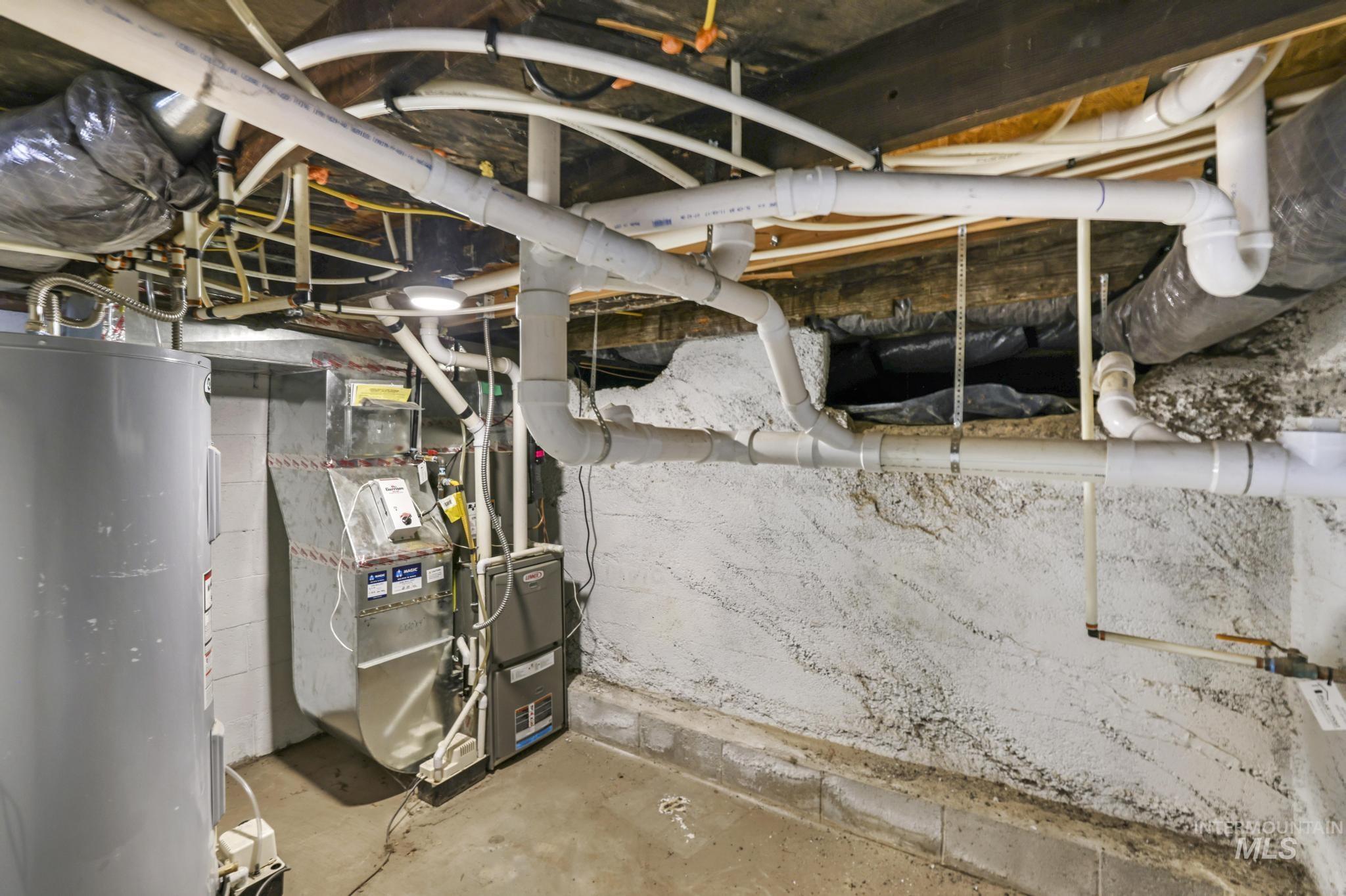 Unfinished basement with electric water heater and heating unit