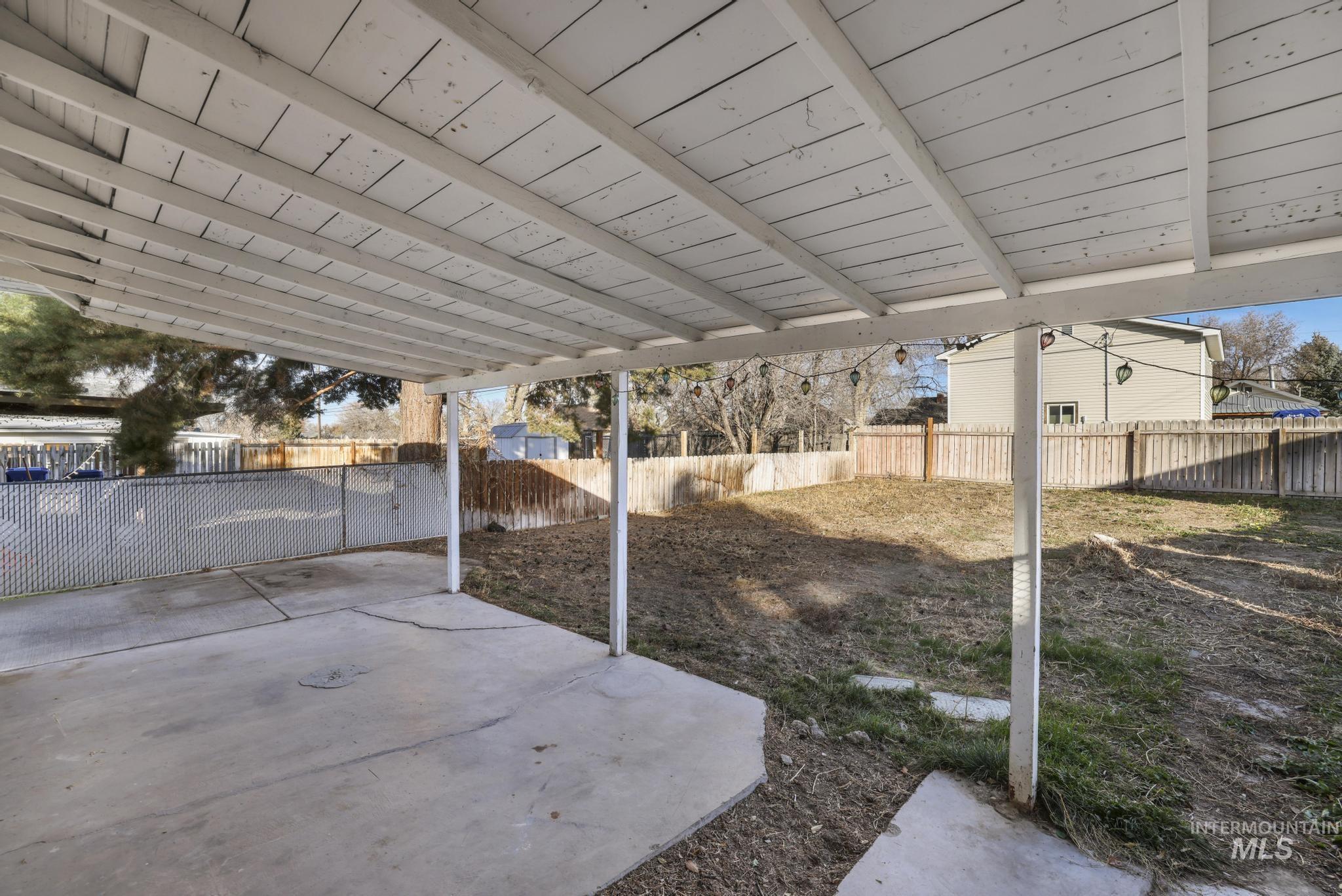 Fenced backyard with a patio