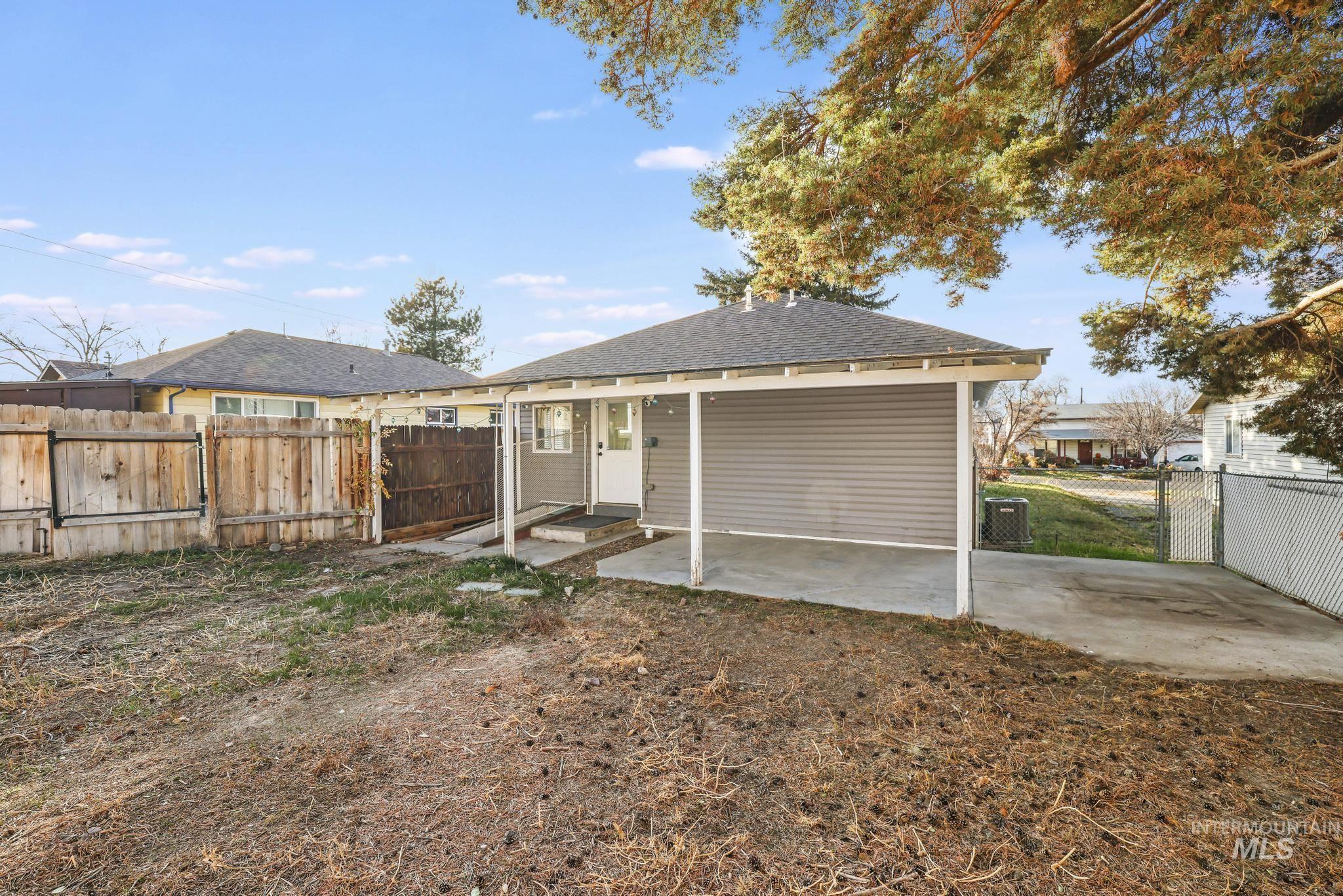 Back of property with a fenced backyard, a patio, a gate, and roof with shingles