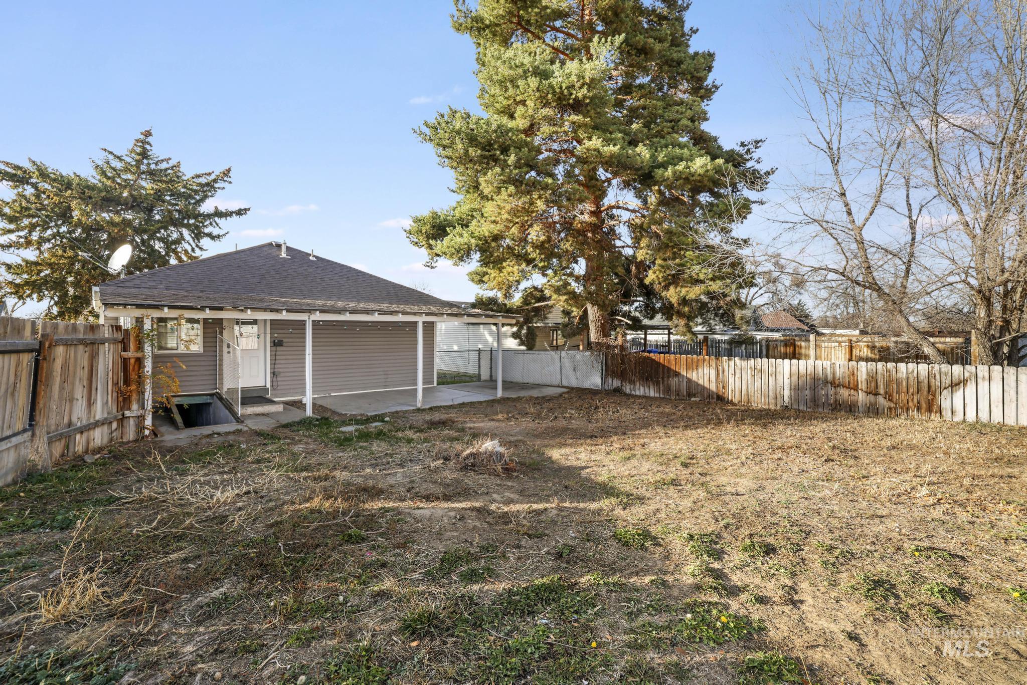 Rear view of property featuring a patio area, a fenced backyard, roof with shingles, and entry steps