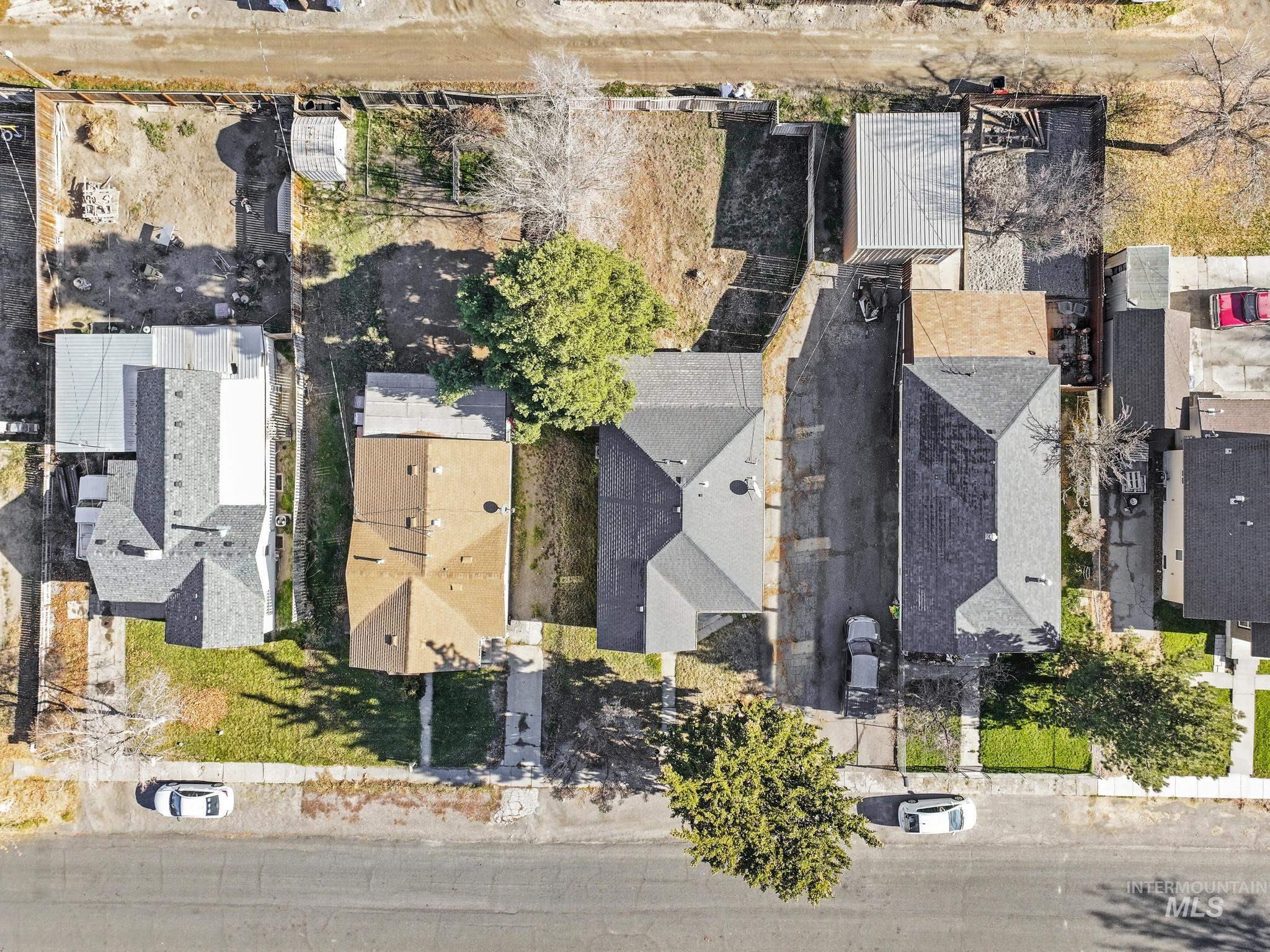 Aerial view of property and surrounding area featuring nearby suburban area