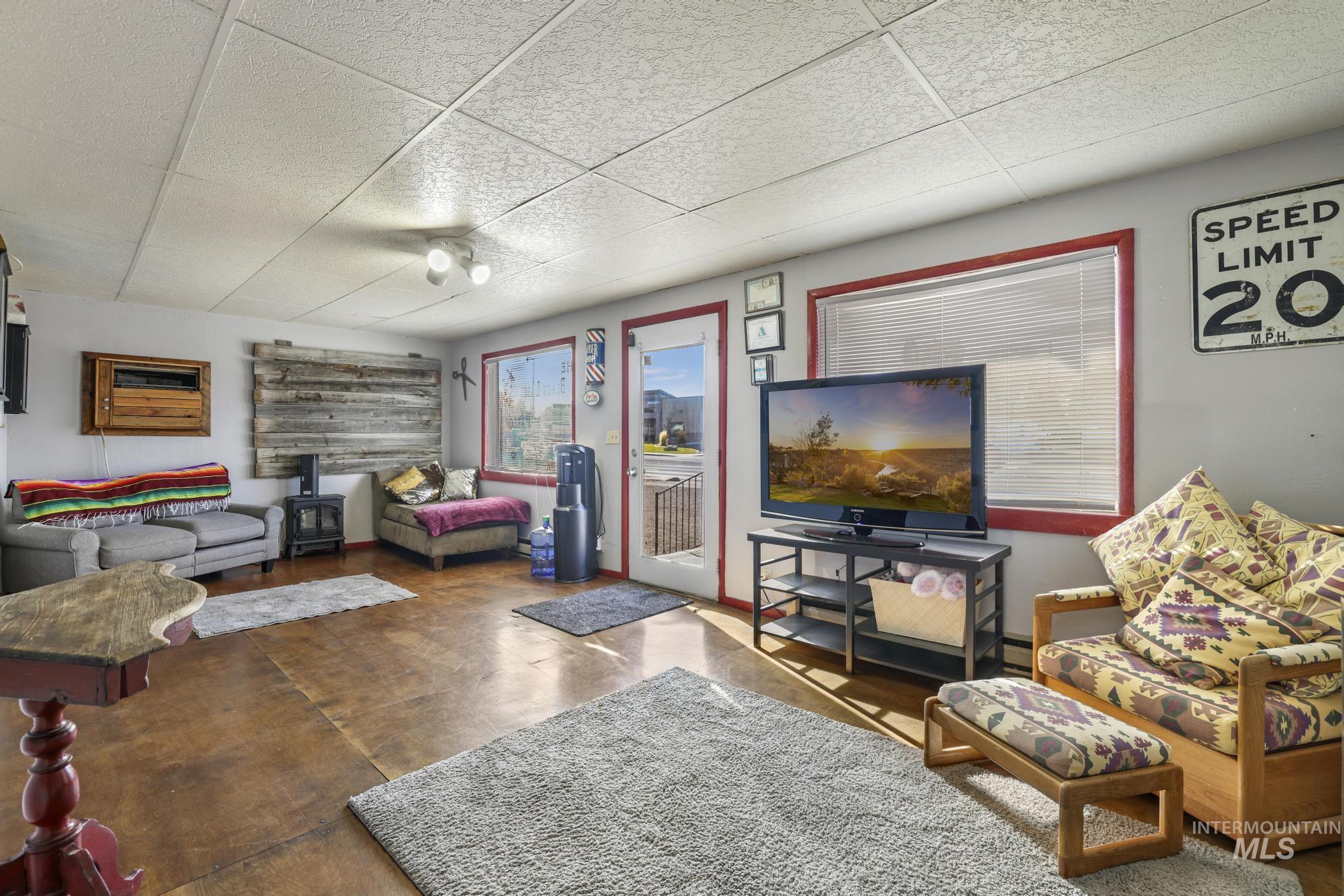 Living area with finished concrete flooring and a wall unit AC