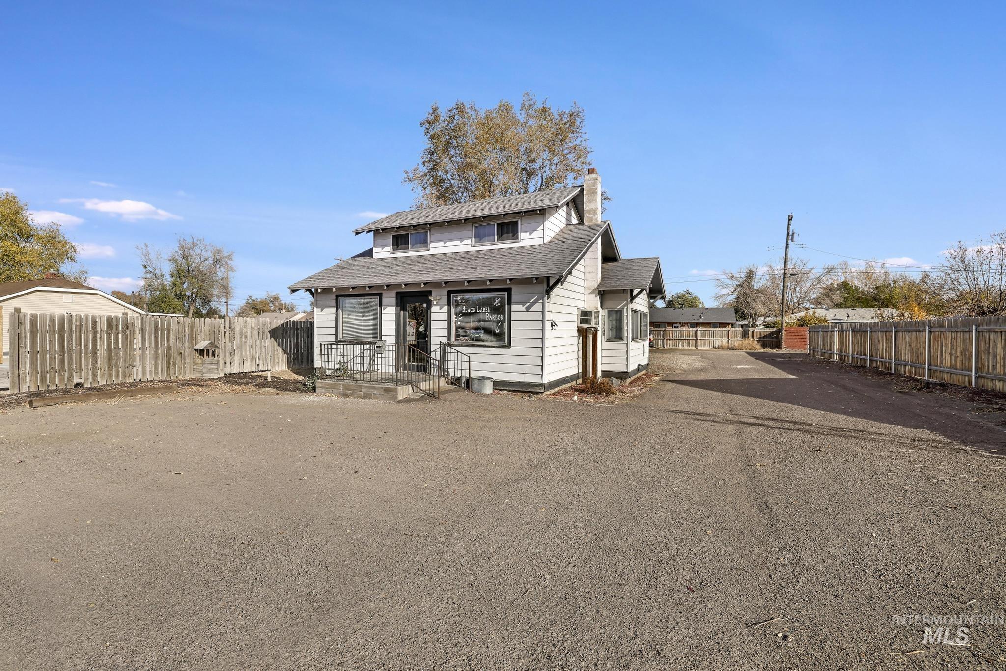 Bungalow with a chimney and roof with shingles